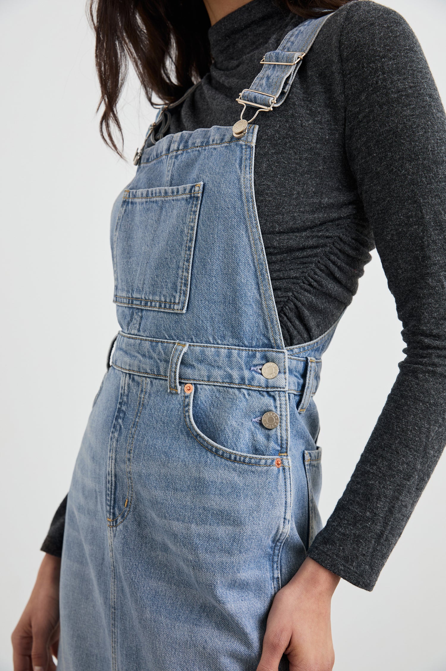 Westlake Midi Denim Dress with an Overalls-Style Bodice, Two Front Pockets, a Bib Chest Patch Pocket, Two Back Patch Pockets, Belt Loops and a Center Slit in South Coast Colorway - Front View Featured on Model