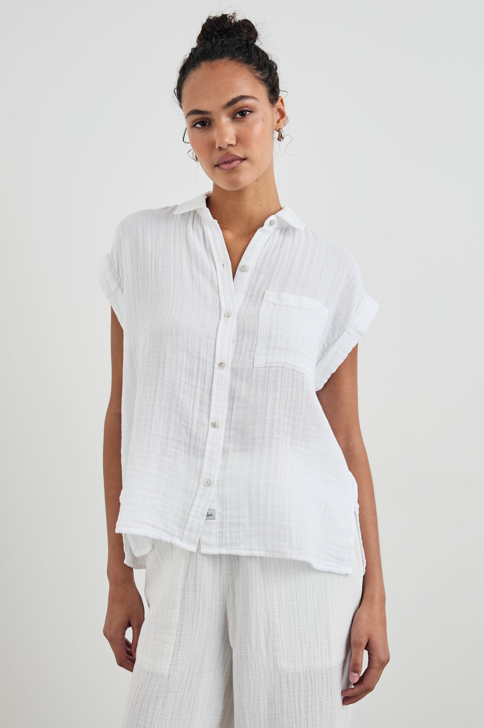 Whitney Short Rolled Sleeves Button Up with a Chest Patch Pocket and Short Side Slits in White Colorway - Front View Featured on Model