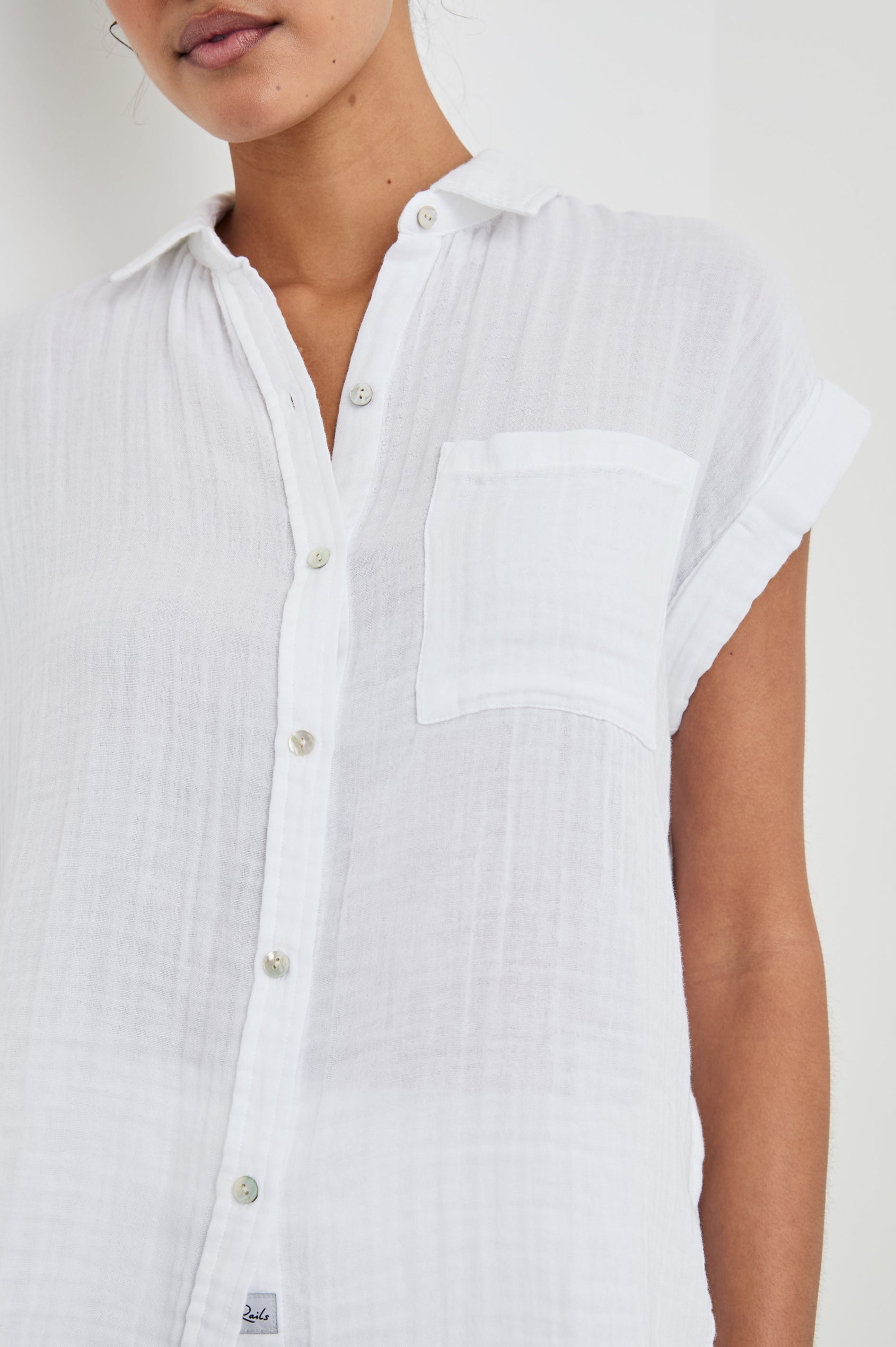 Whitney Short Rolled Sleeves Button Up with a Chest Patch Pocket and Short Side Slits in White Colorway - Front View Featured on Model