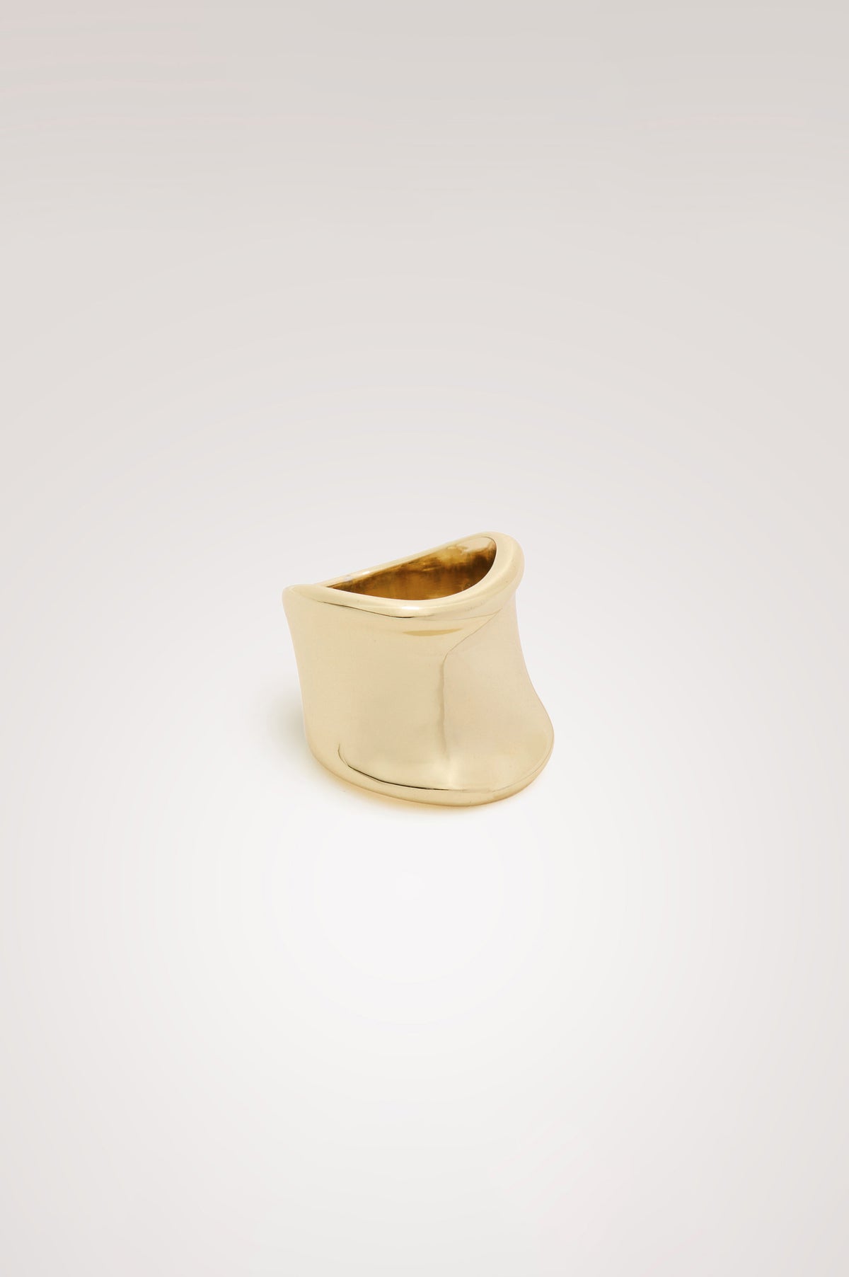 Wide Curved Ring With Engraved Rails Logo at Interior in Gold Colorway - Front view featured.