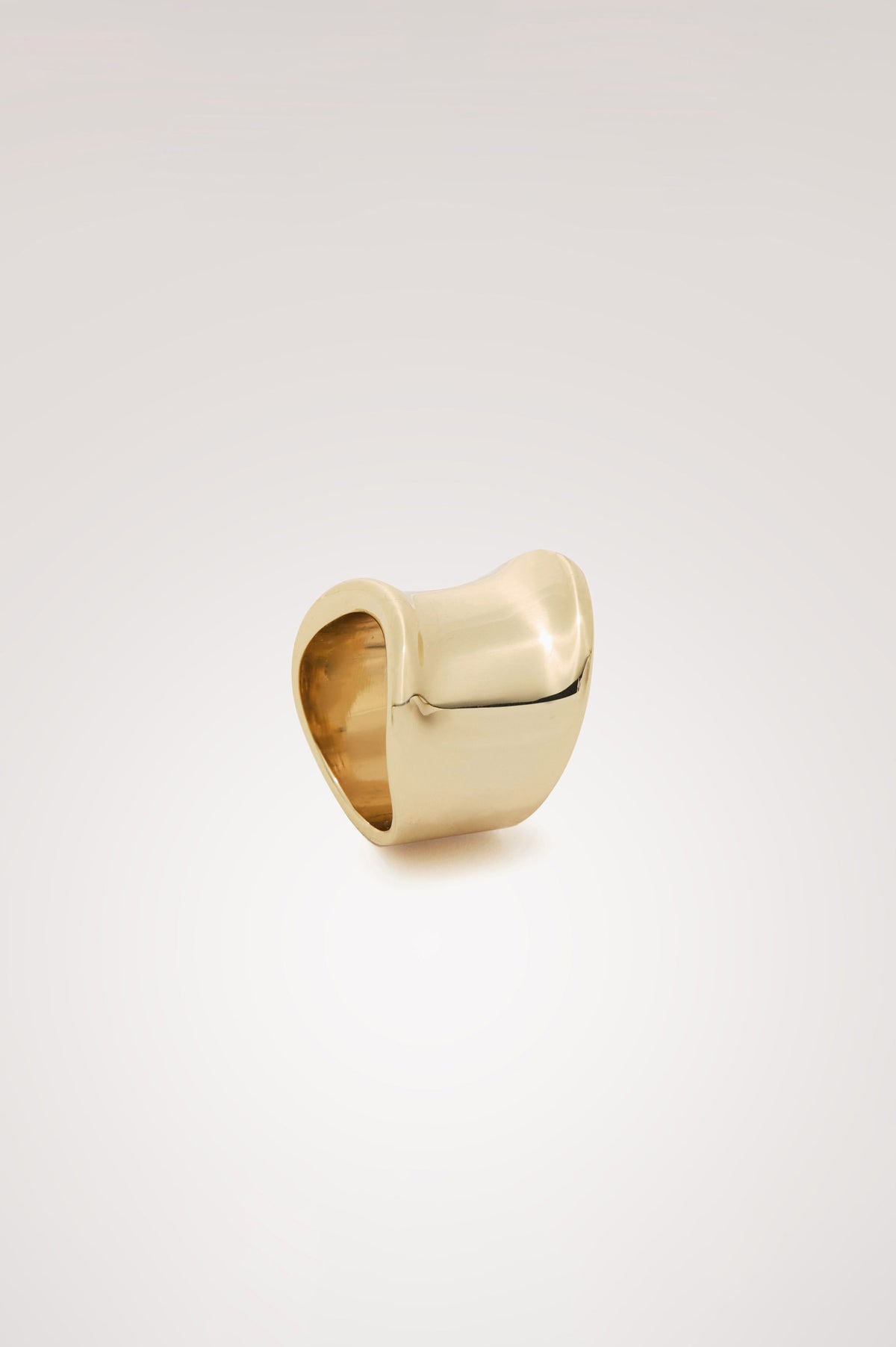 Wide Curved Ring With Engraved Rails Logo at Interior in Gold Colorway - Side view featured