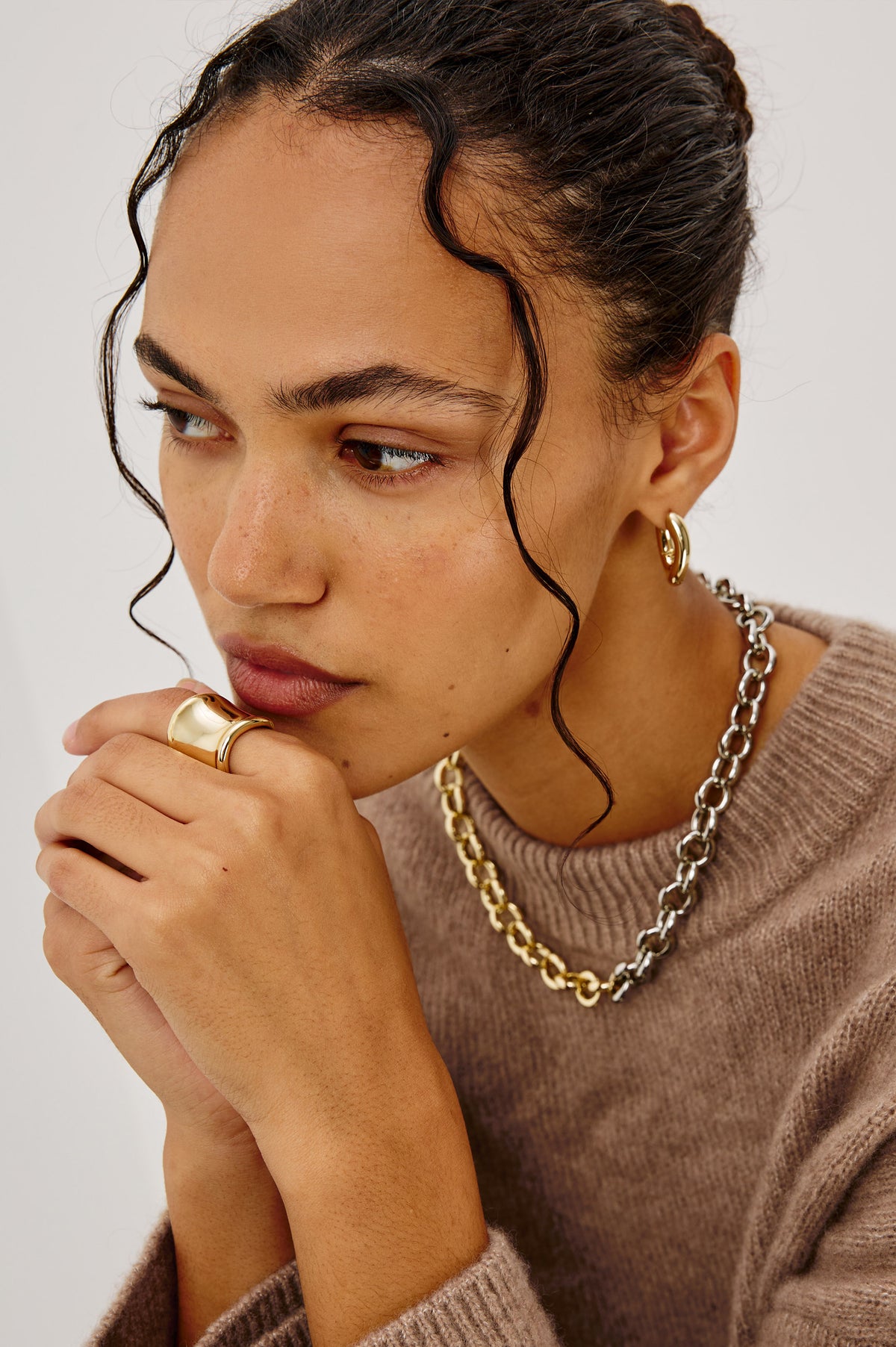 Wide Curved Ring With Engraved Rails Logo at Interior in Gold Colorway - Front view featured on model.