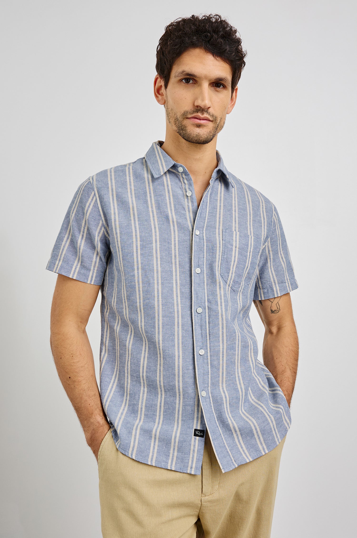 Wilder Collared Button Front Shirt with Short Sleeves and a Chest Pocket in Chambray Butter Colorway. Front View Shown on Model.