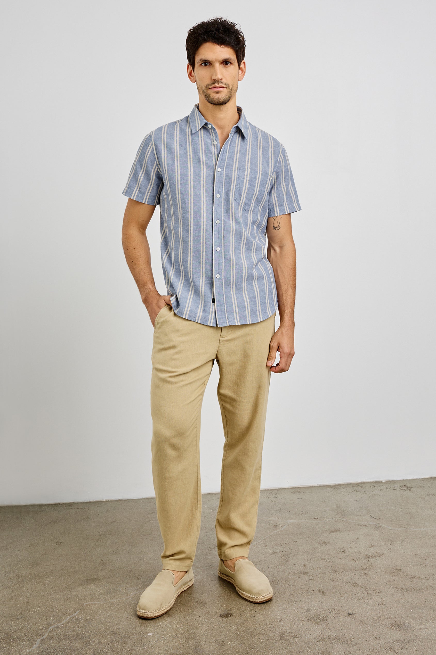 Wilder Collared Button Front Shirt with Short Sleeves and a Chest Pocket in Chambray Butter Colorway. Front View Shown on Model.