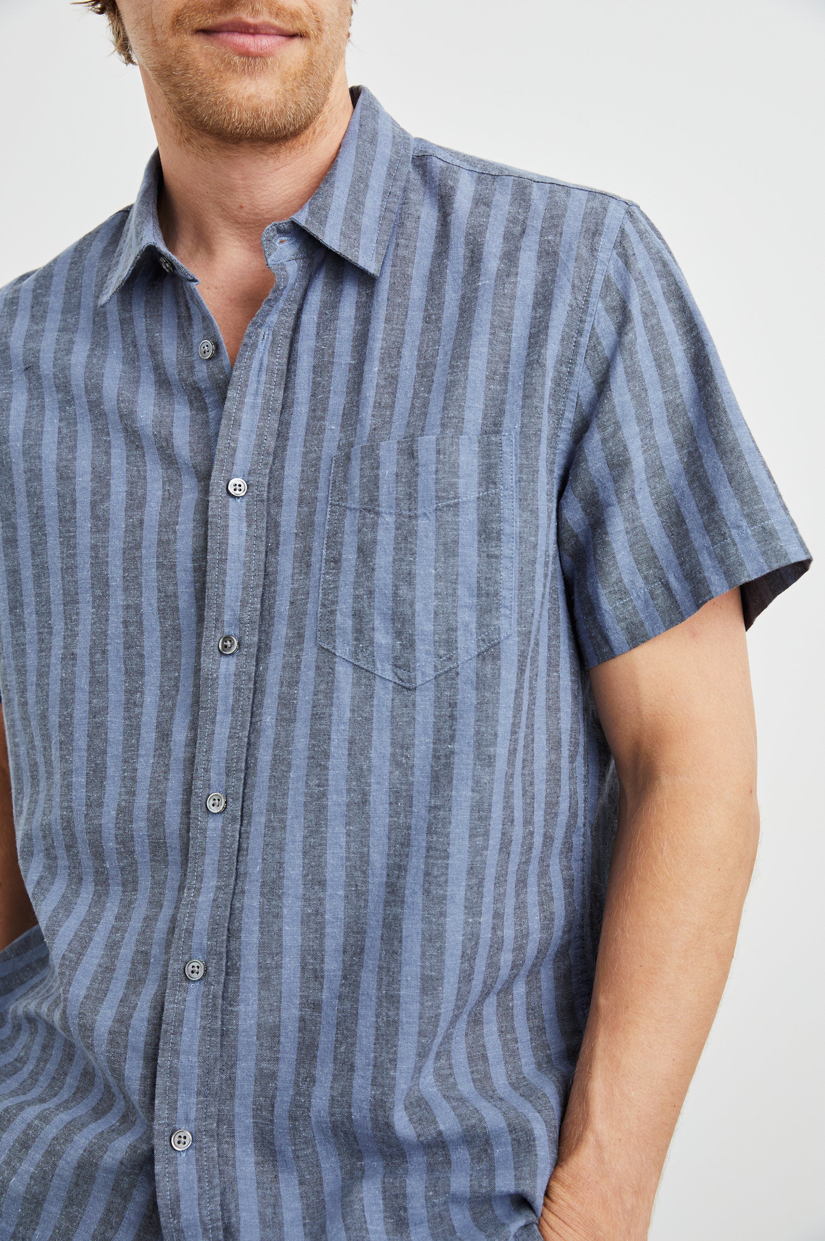  Wilder Short Sleeve Button Up Shirt with Chest Patch Pocket in Marine Sapphire Stripe Colorway, Grey and Blue Vertical Stripes - Front View Featured on Model