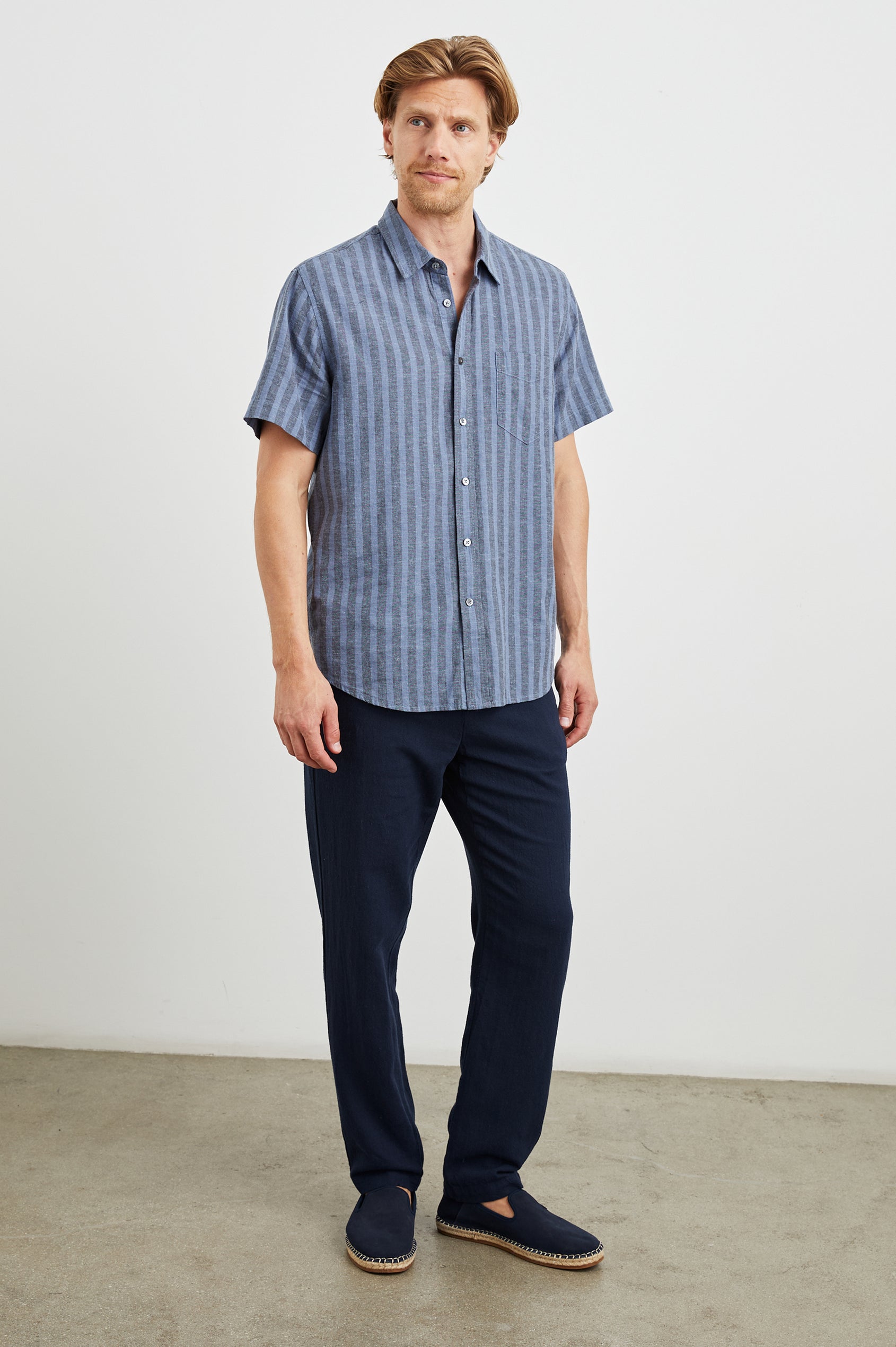 Wilder Short Sleeve Button Up Shirt with Chest Patch Pocket in Marine Sapphire Stripe Colorway, Grey and Blue Vertical Stripes - Front Full Body View Featured on Model