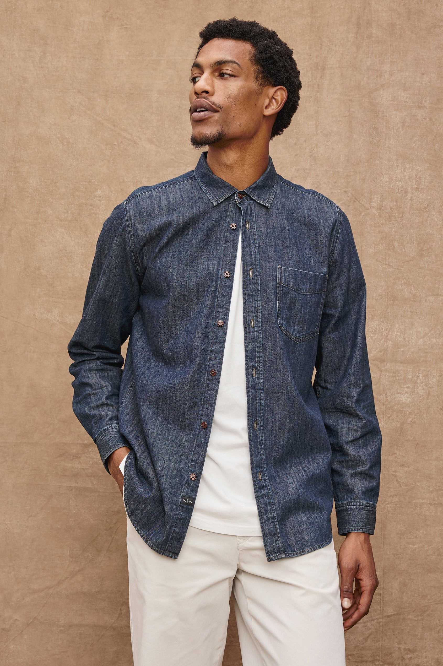 Colton Long-Sleeve Denim Button Up with a Chest Patch Pocket in Dark Wash Indigo Colorway - Front Unbuttoned View Featured on Model 