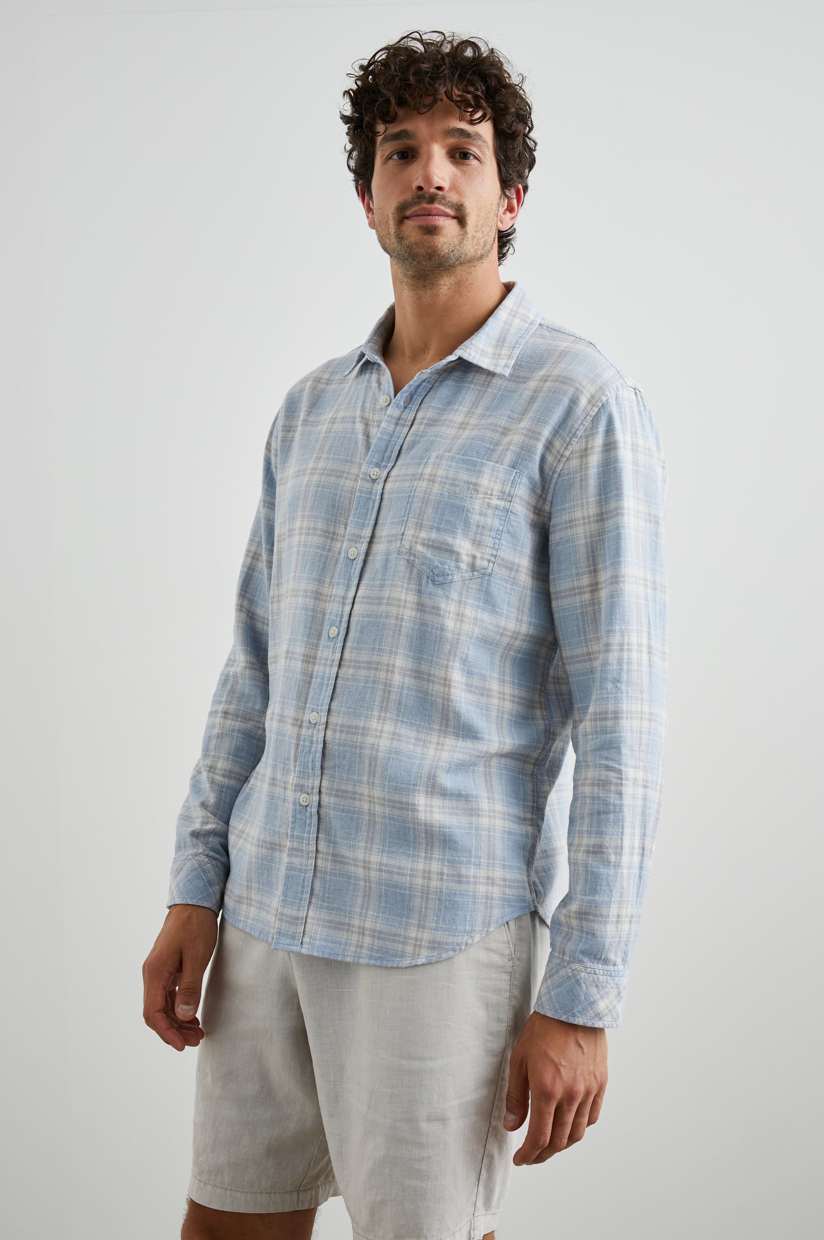 Wyatt Long-Sleeve Button Up with a Chest Patch Pocket in Rose Waterfall Colorway, a blue, grey and white plaid - Front View Featured on Model