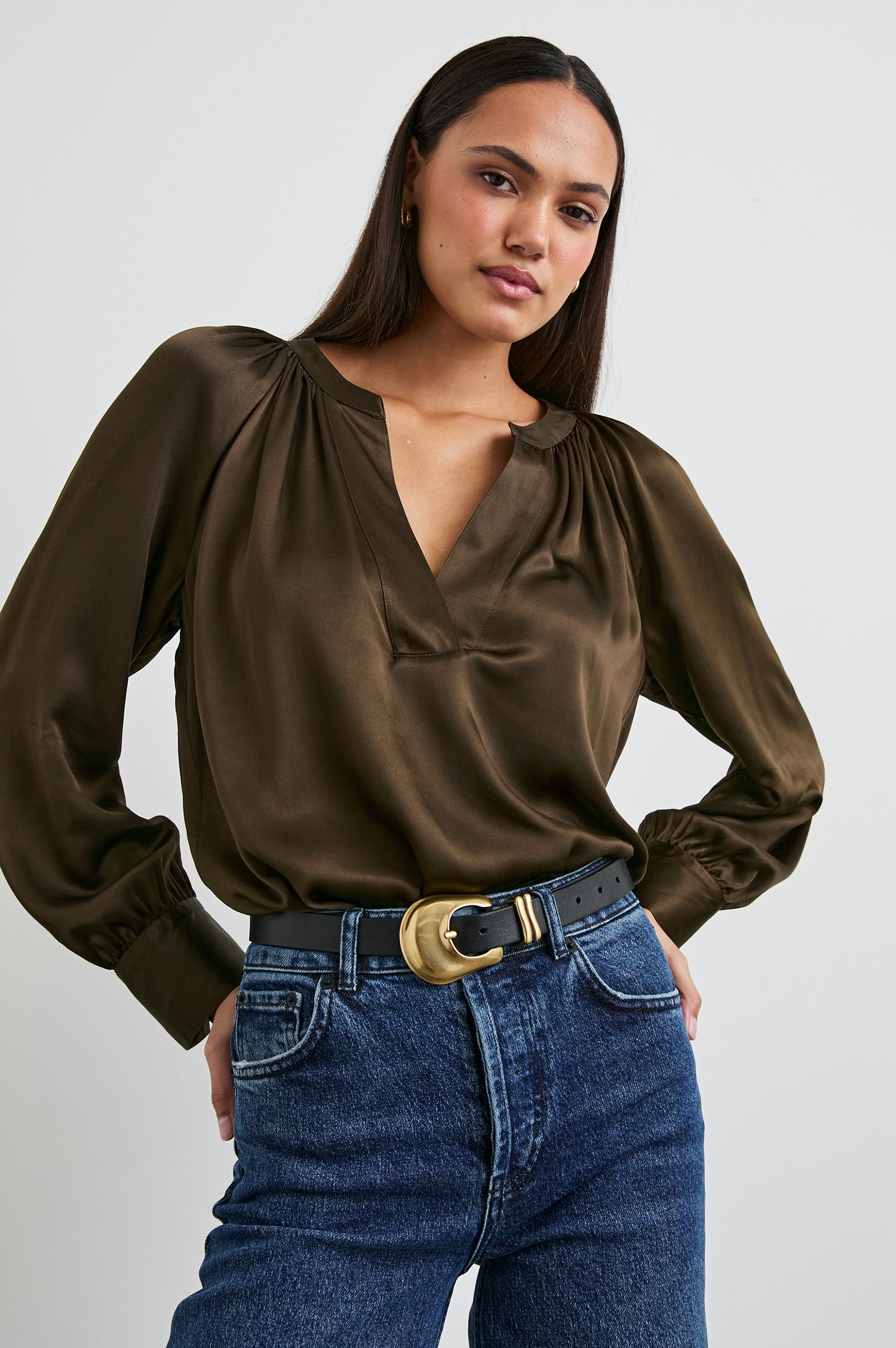 Wynna Long-Sleeve Top with a Deep V Neck and Ruching above the Cuffs and at the Neckline in Dark Moss Colorway - Front Tucked View Featured on Model