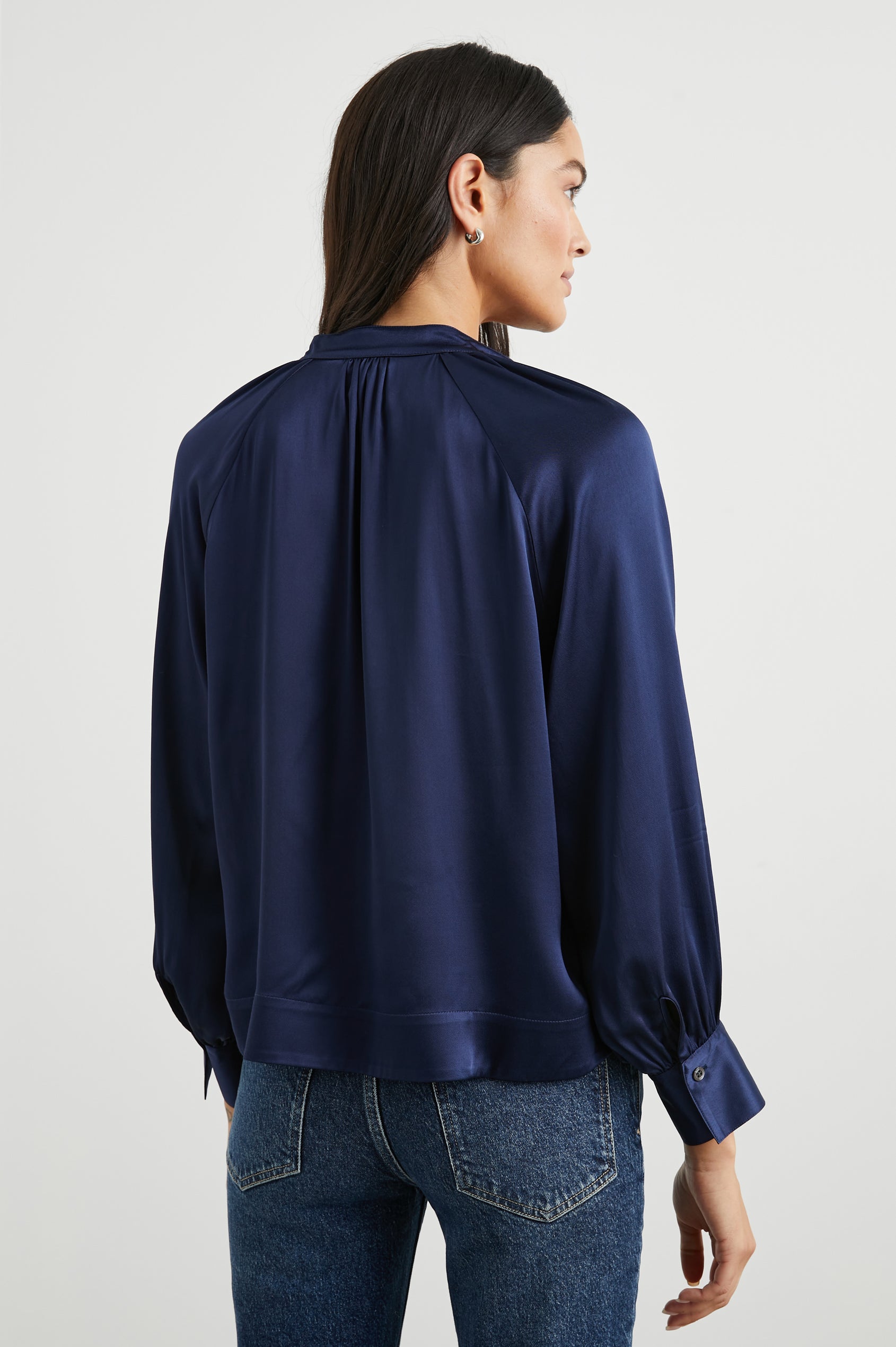 Wynna Long-Sleeve Top with a Deep V Neck and Ruching above the Cuffs and at the Neckline in Navy Colorway - Back View Featured on Model