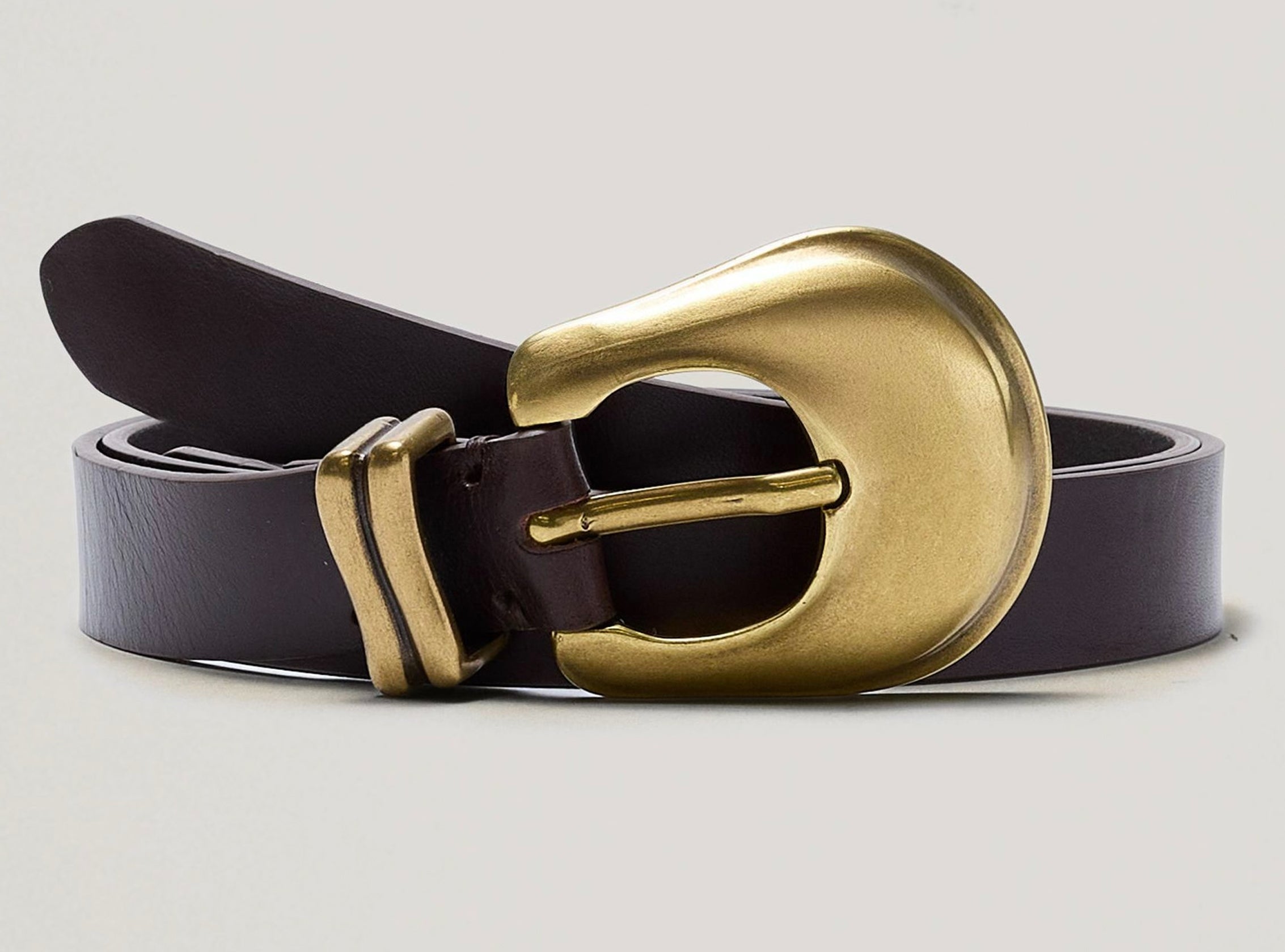 Brown belt with a gold buckle on a light gray background