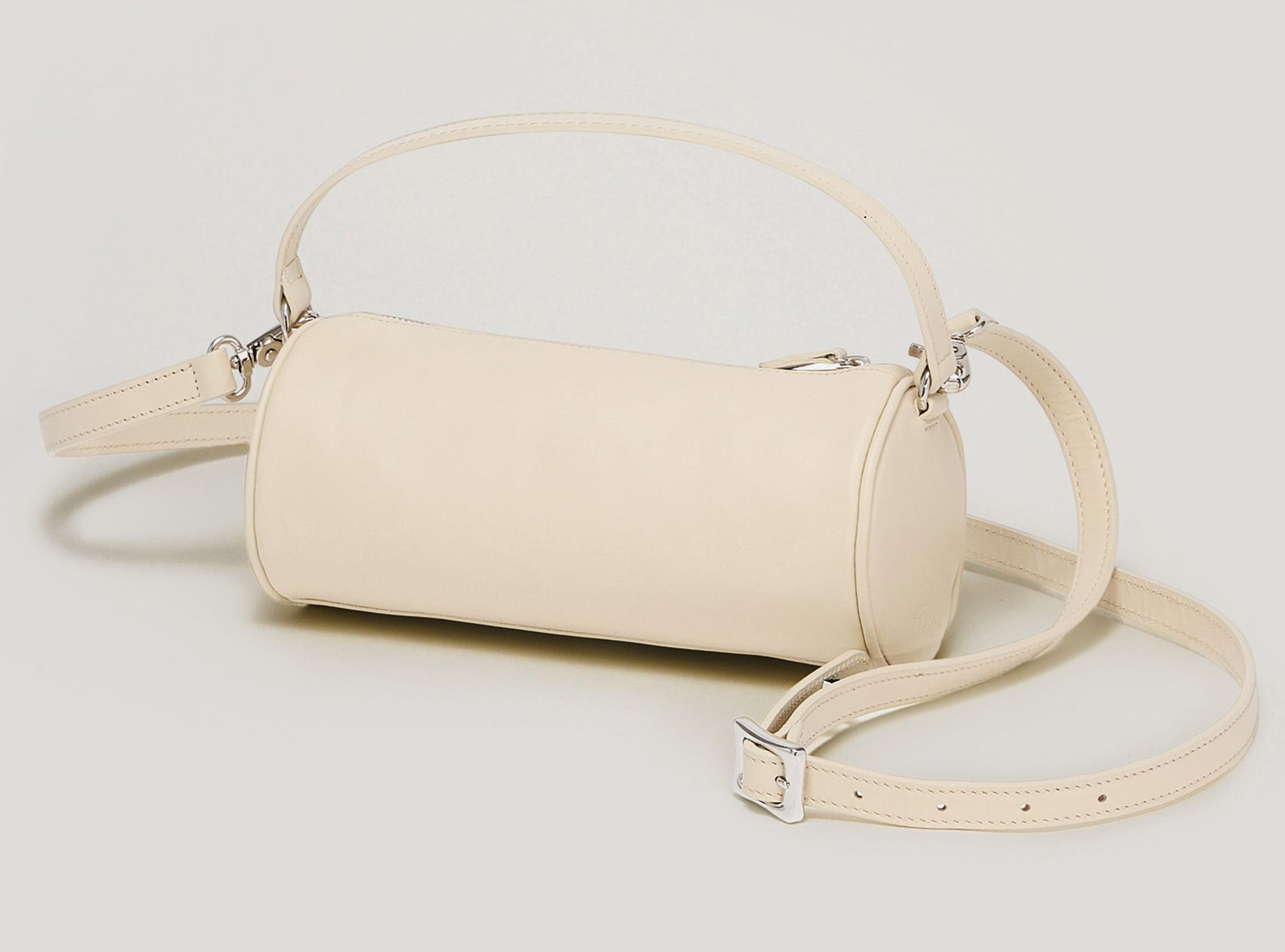 Beige handbag with a strap on a light gray background