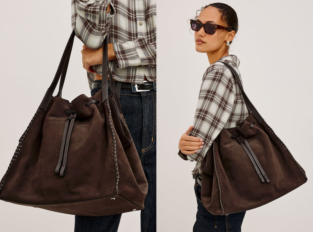 A dark brown suede drawstring bucket bag shown in a split view: on the left, held by a model from the side, and on the right, worn over the shoulder by a model in a plaid shirt and sunglasses. The background is a clean, neutral off-white studio backdrop.