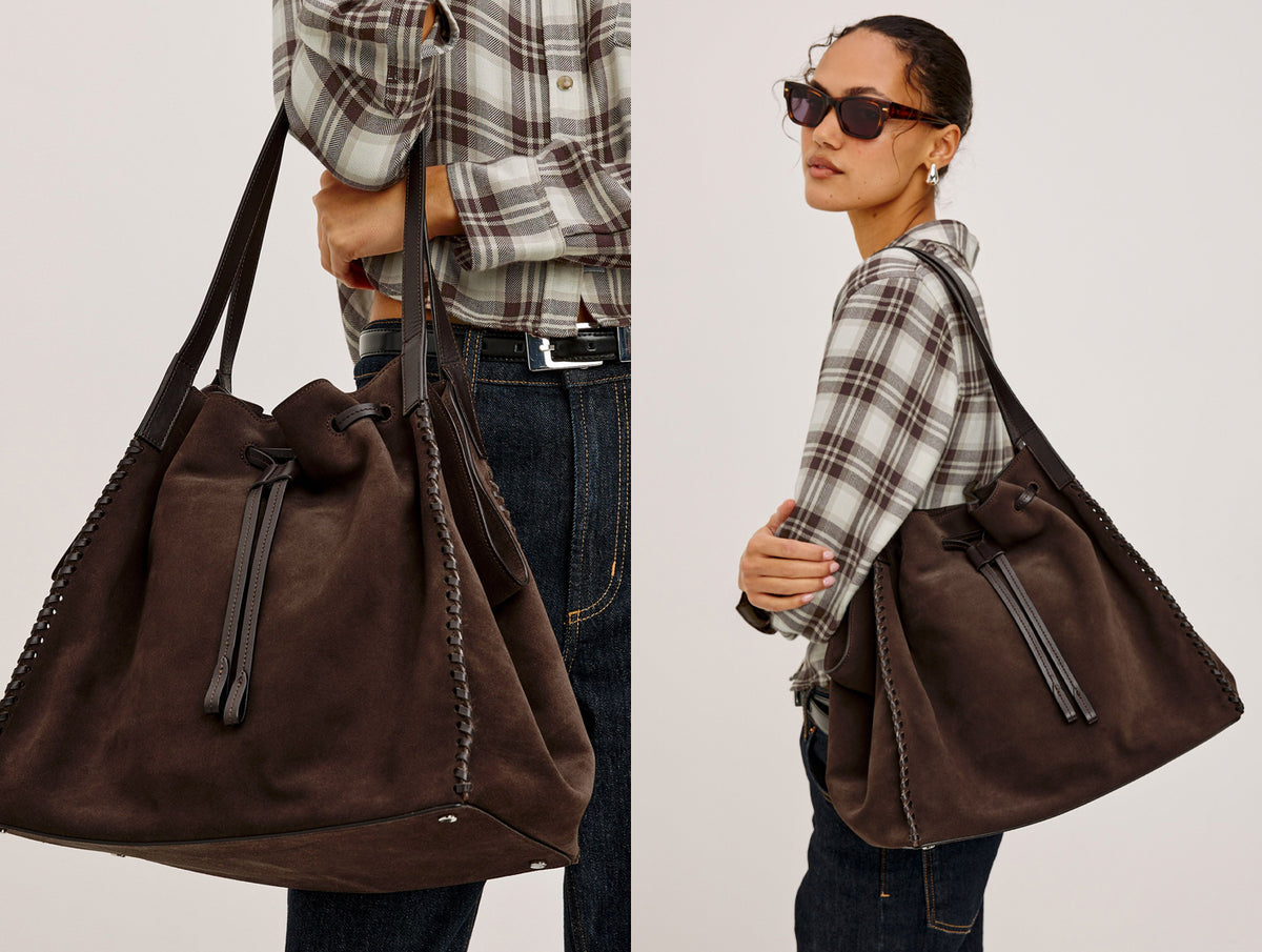 A dark brown suede drawstring bucket bag shown in a split view: on the left, held by a model from the side, and on the right, worn over the shoulder by a model in a plaid shirt and sunglasses. The background is a clean, neutral off-white studio backdrop.