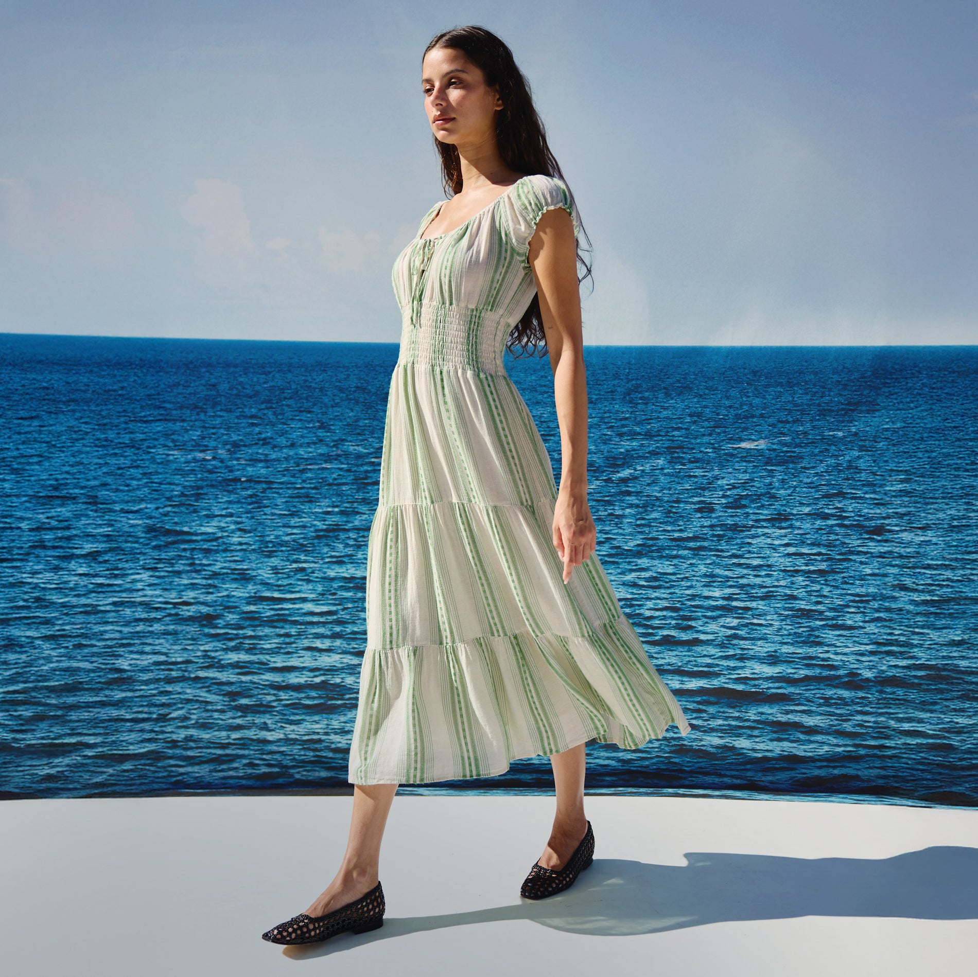 Woman in a green and white striped dress
