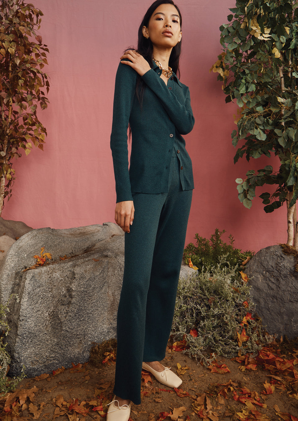 FULL BODY EDITORIAL IMAGE OF MODEL WEARING RORY SWEATER AND JULES PANT