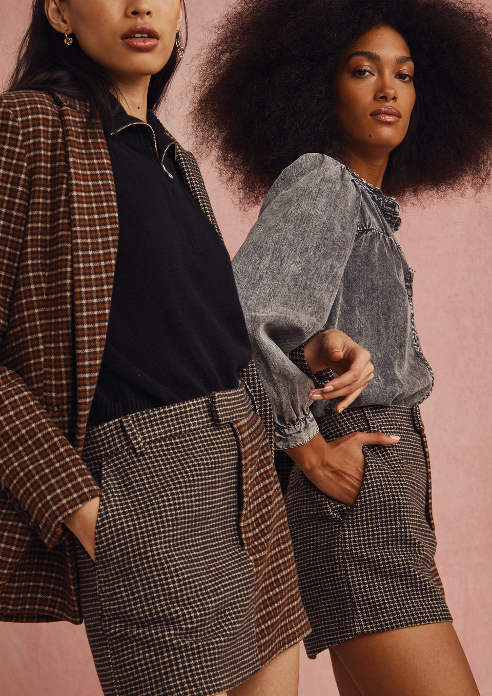 TWO MODELS STANDING NEXT TO EACH OTHER. FIRST MODEL IS WEARING CODY BLAZER AND PRIM SKIRT. SECOND MODEL IS WEARING CAMILLE TOP. 