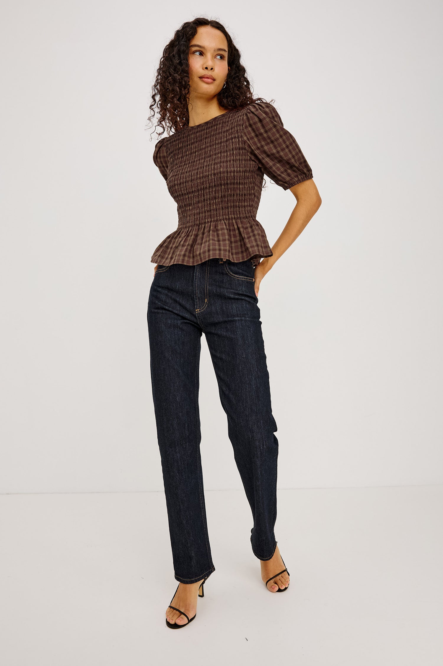 Zane Shirt in Brushed Cotton With Fitted Smocked Body, Elbow-Length Puff Sleeves With Elastic Cuffs, Adjustable Keyhole Tie at Back, and Peplum Hem in Espresso Olive Colorway - Full Body Front View Featured on Model