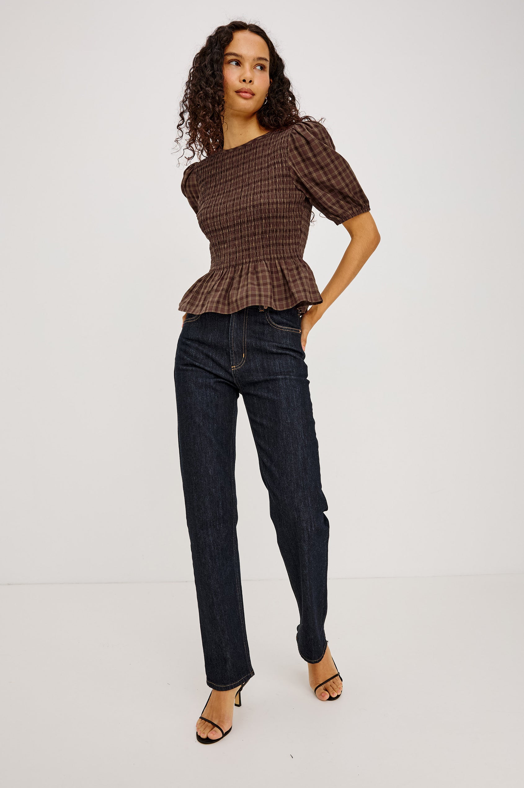 Zane Shirt in Brushed Cotton With Fitted Smocked Body, Elbow-Length Puff Sleeves With Elastic Cuffs, Adjustable Keyhole Tie at Back, and Peplum Hem in Espresso Olive Colorway - Full Body Front View Featured on Model