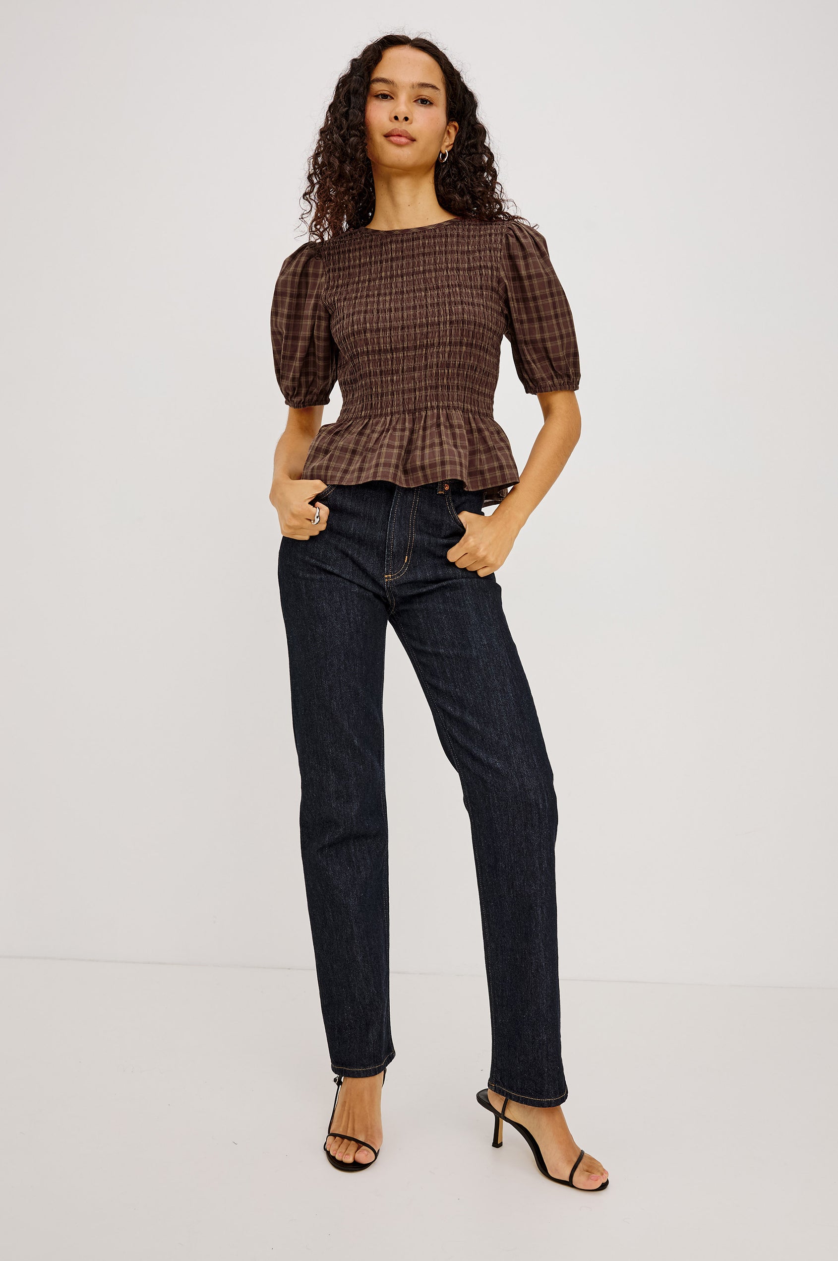 Zane Shirt in Brushed Cotton With Fitted Smocked Body, Elbow-Length Puff Sleeves With Elastic Cuffs, Adjustable Keyhole Tie at Back, and Peplum Hem in Espresso Olive Colorway - Full Body Front View Featured on Model