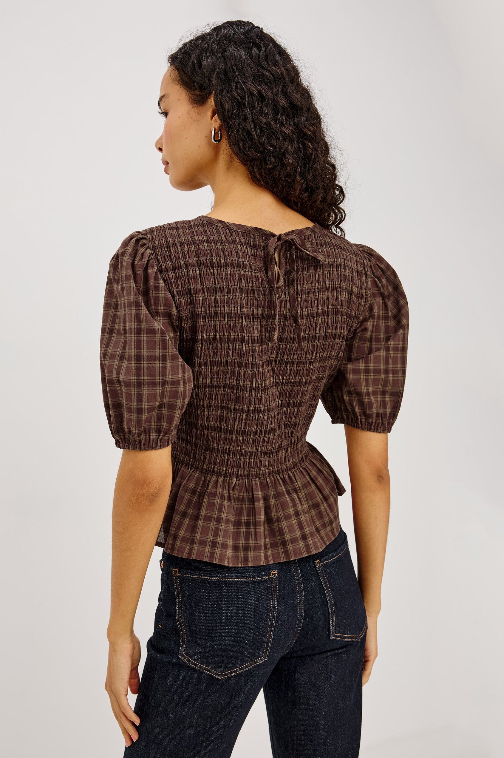 Zane Shirt in Brushed Cotton With Fitted Smocked Body, Elbow-Length Puff Sleeves With Elastic Cuffs, Adjustable Keyhole Tie at Back, and Peplum Hem in Espresso Olive Colorway - Upper Body Back View Featured on Model