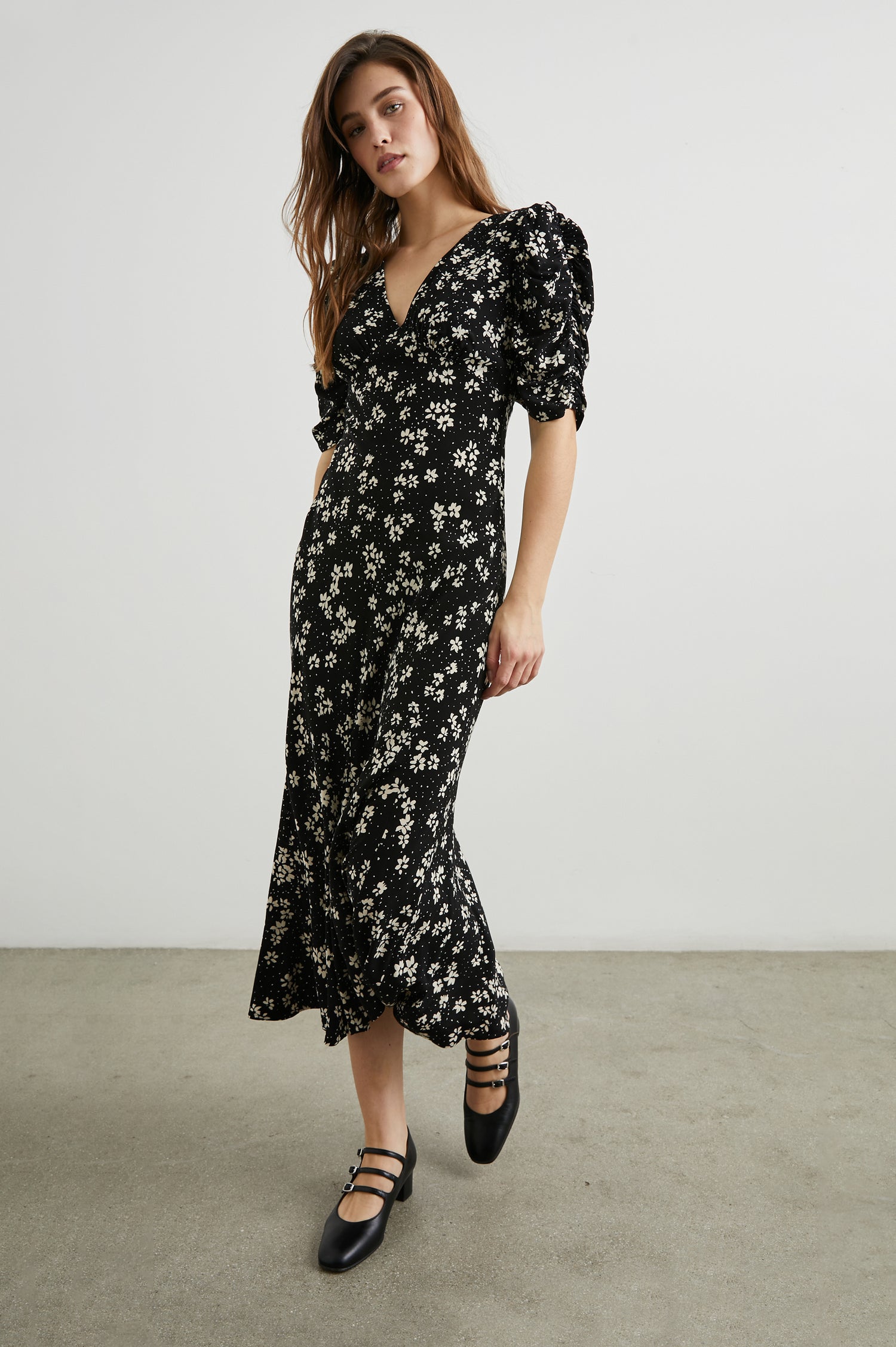 Zariah Midi Dress with Mid-Length Sleeves with Light Ruching, a Deep V Neck and an Empire Waist in Noir Floral Colorway, with white flowers on black - Front Full Body View Featured on Model