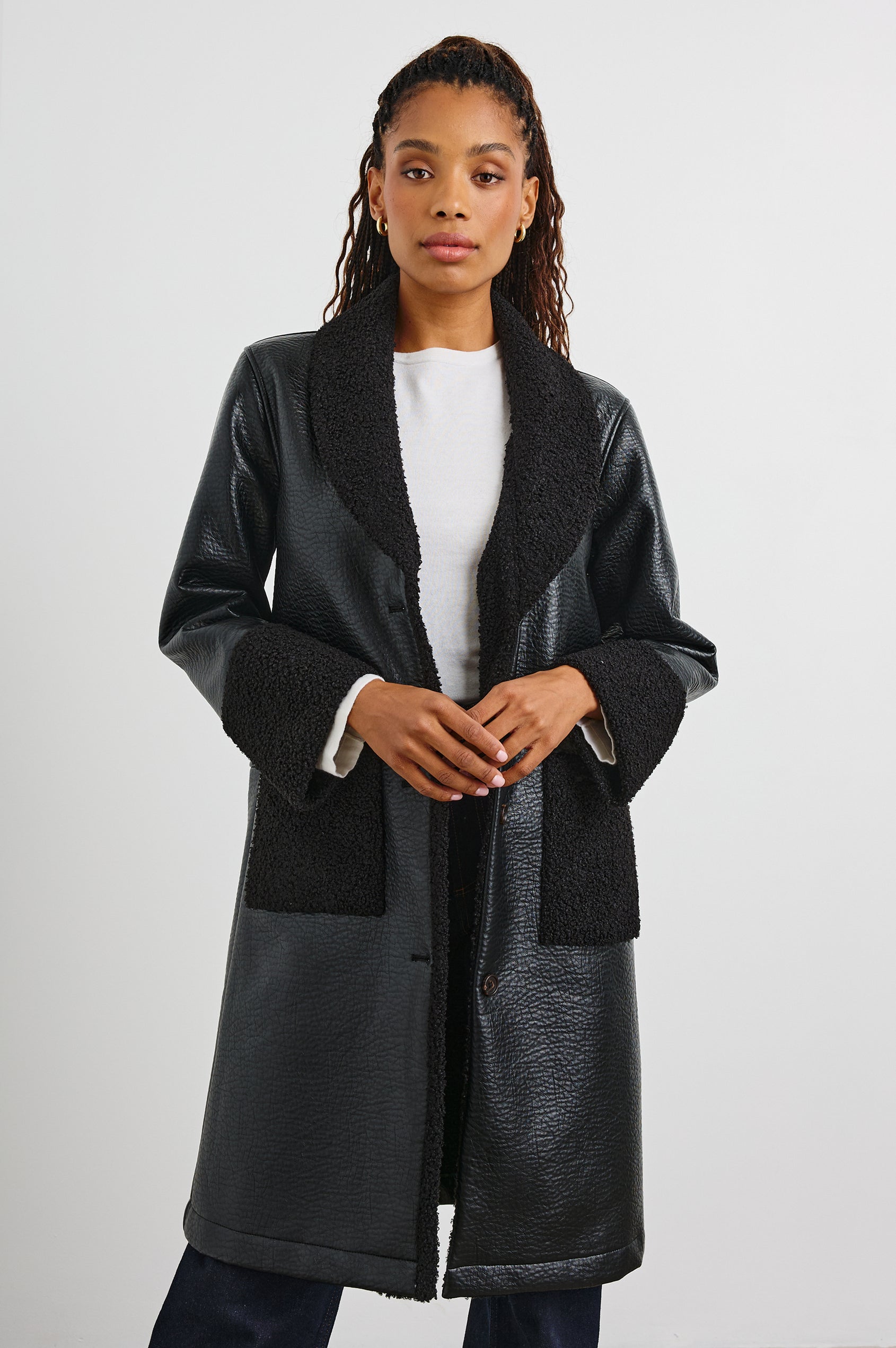 Zodiac Jacket with Button Closure Starting at the Mid-Chest and Two Front Patch Pockets in Black Shearling Colorway, with the Collar, Cuffs and Pockets in Faux Shearling - Front View Featured on Model