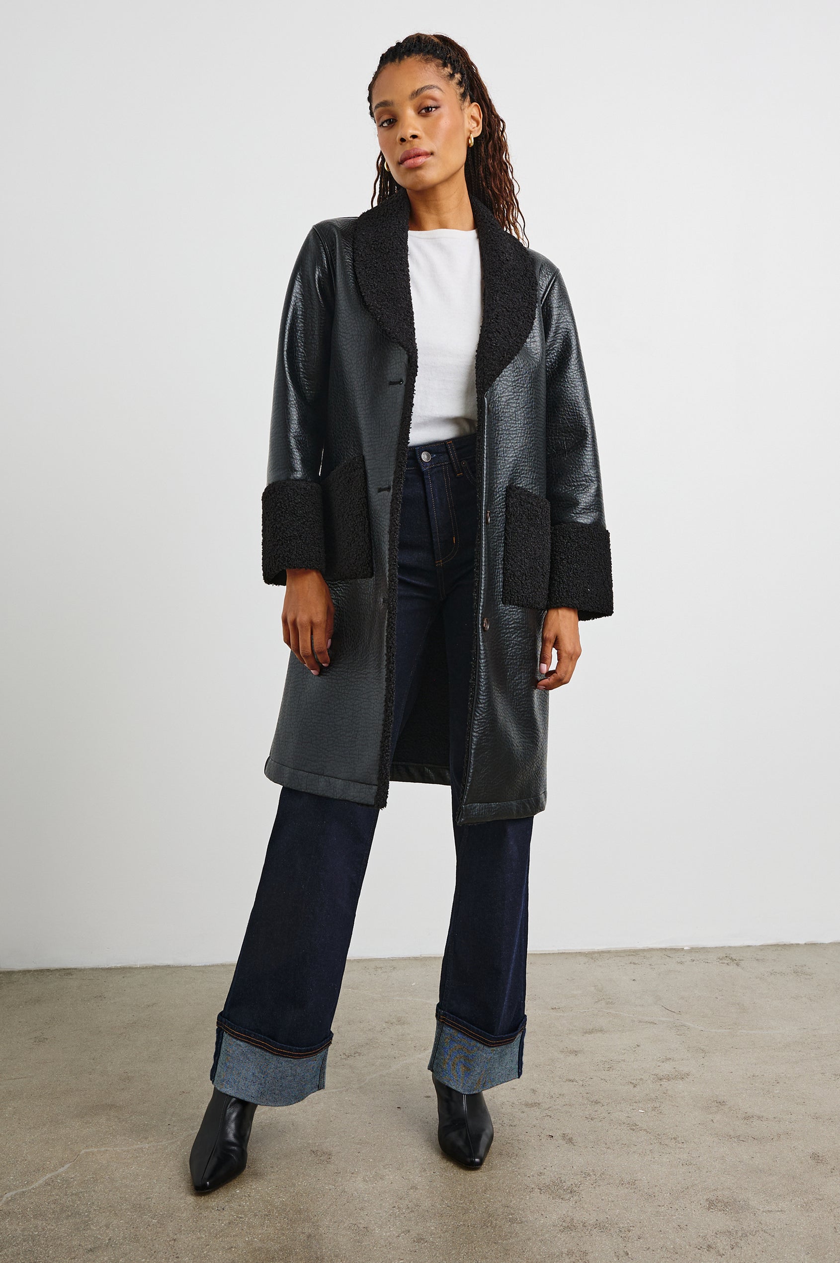 Zodiac Jacket with Button Closure Starting at the Mid-Chest and Two Front Patch Pockets in Black Shearling Colorway, with the Collar, Cuffs and Pockets in Faux Shearling - Front Full Body View Featured on Model