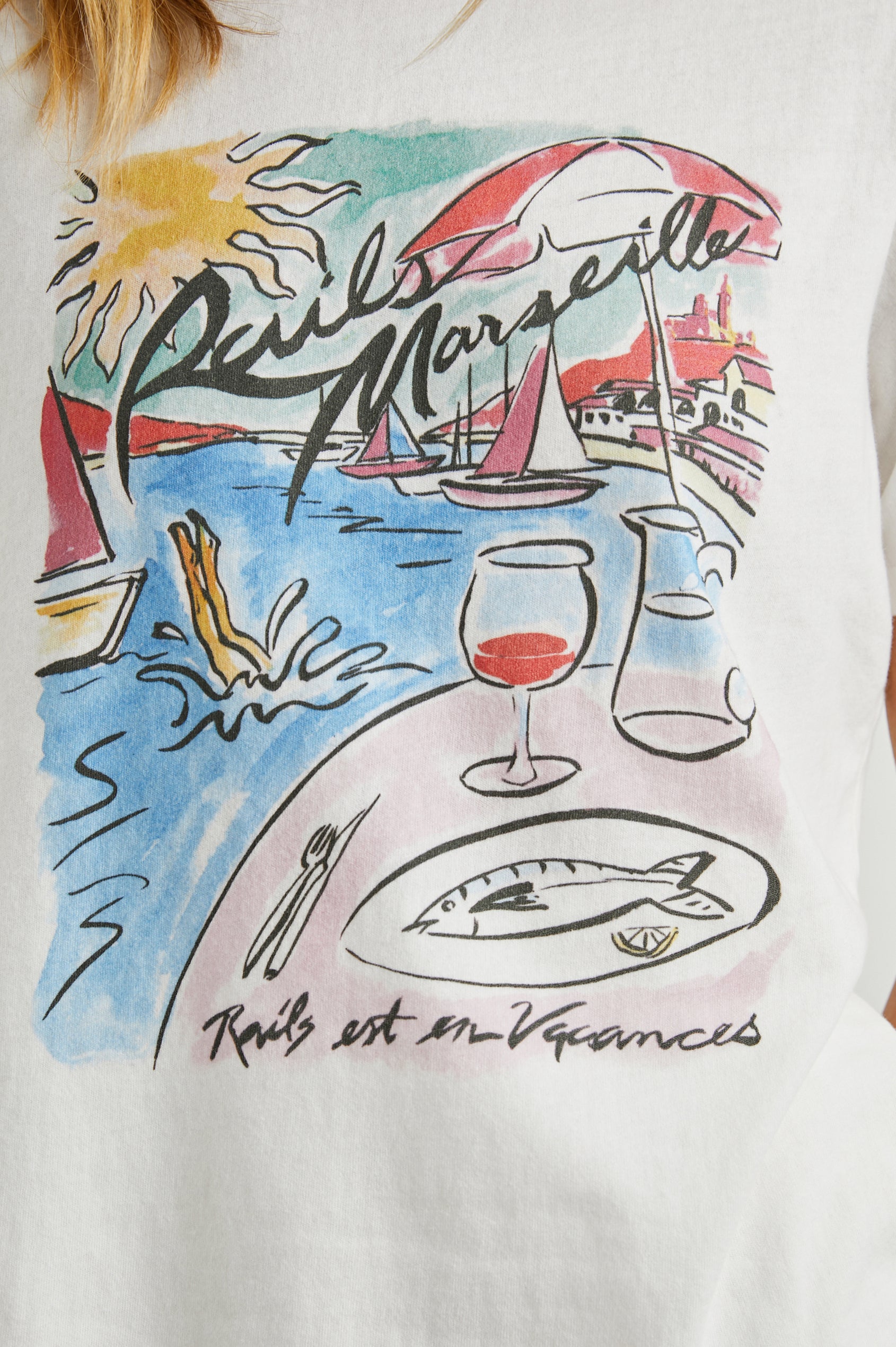 Boyfriend T-Shirt with a Crew Neck, a seaside image and the text, Rails Marseille Rails et en Vacances in Rails Marseille Colorway, with text and image in black and pinks on a White shirt - Front View Featured on Model