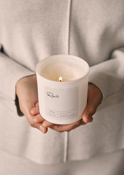EDITORIAL IMAGE OF MODEL HOLDING A CANDLE