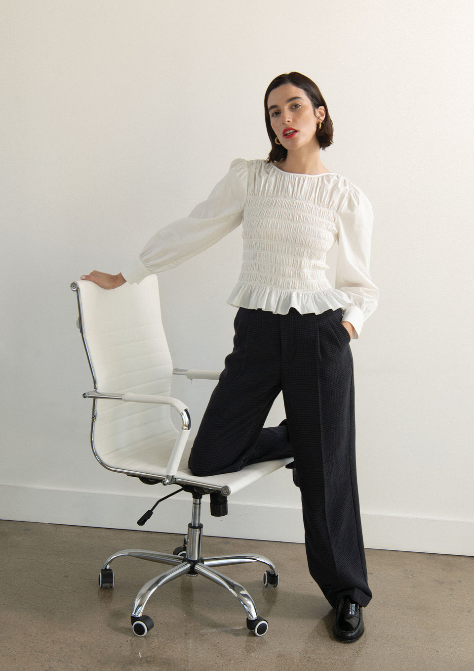 EDITORIAL FRONT SHOT OF MODEL WEARING TABI TOP IN WHITE AND MARNIE PANT IN MIDNIGHT BROWN MINI CHECK