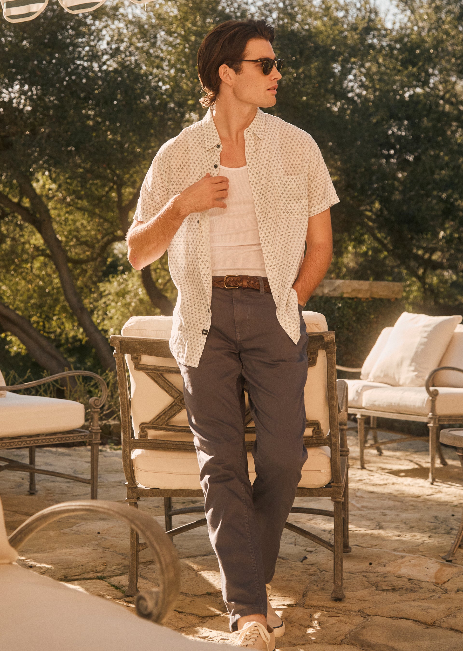 EDITORIAL FULL BODY IMAGE OF MODEL WEARING CARSON SHIRT IN DIAMOND GEO CREAM AND CARVER PANT IN ENSIGN BLUE