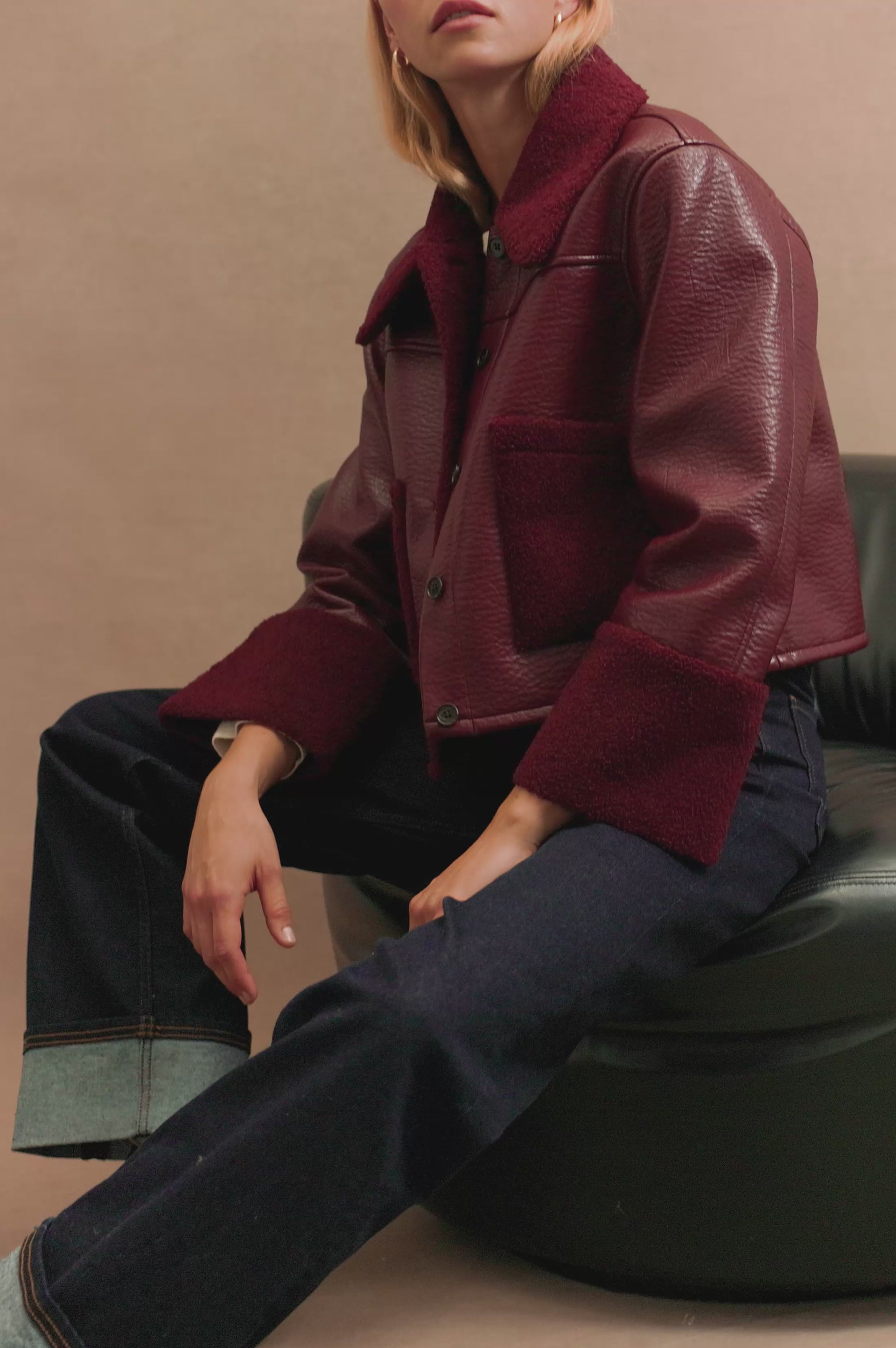 (Video): Dria jacket in maroon shearling, showcasing the plush texture and cozy button-front fit. Full body view of model featured with close up views.