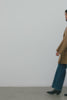 (Video): Hugo Coat in Camel shown on a model to showcase the heavy wool blend material, double-breasted design, patch pockets, and fringe details. Full Body View Featured on Model.