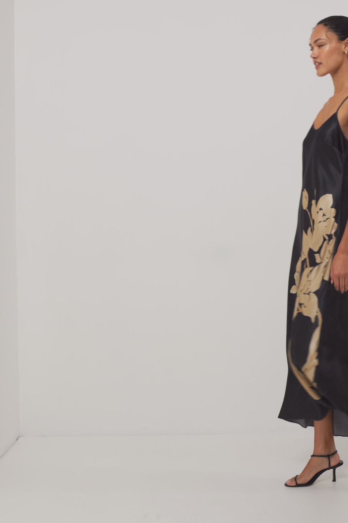 Jaya Midi Dress in Satin-Back Crepe With Scoop Neckline and Adjustable Spaghetti Straps in Gold Lily Colorway - Full Body Front View Featured on Model Moving (Video).