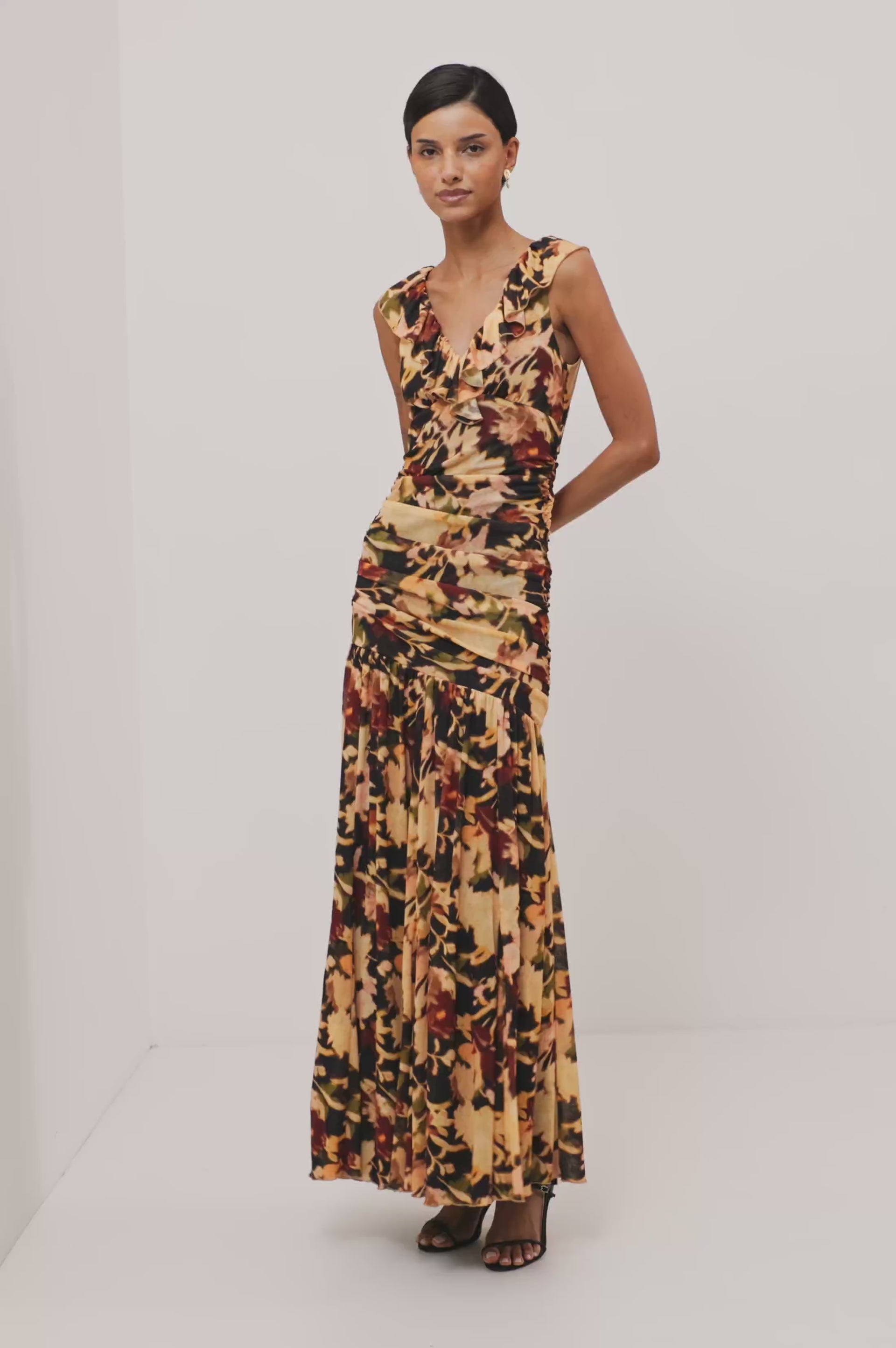 Veda Maxi Dress in Self-Lined Mesh With Sleeveless Cut, Full Lining, Ruffle V-Neckline, Ruched Bodice, and A-Line Skirt in Dark Flora Colorway - Full Body Front View Featured on Model - Video