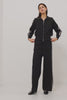 Tucker Pant in Soft Structured Knit With Wide Straight Legs, Drawstring Waist Ties, and Crochet Side Stripes in Black Merlot Stripe Colorway - Full Body View Featured on Model Moving (Video).