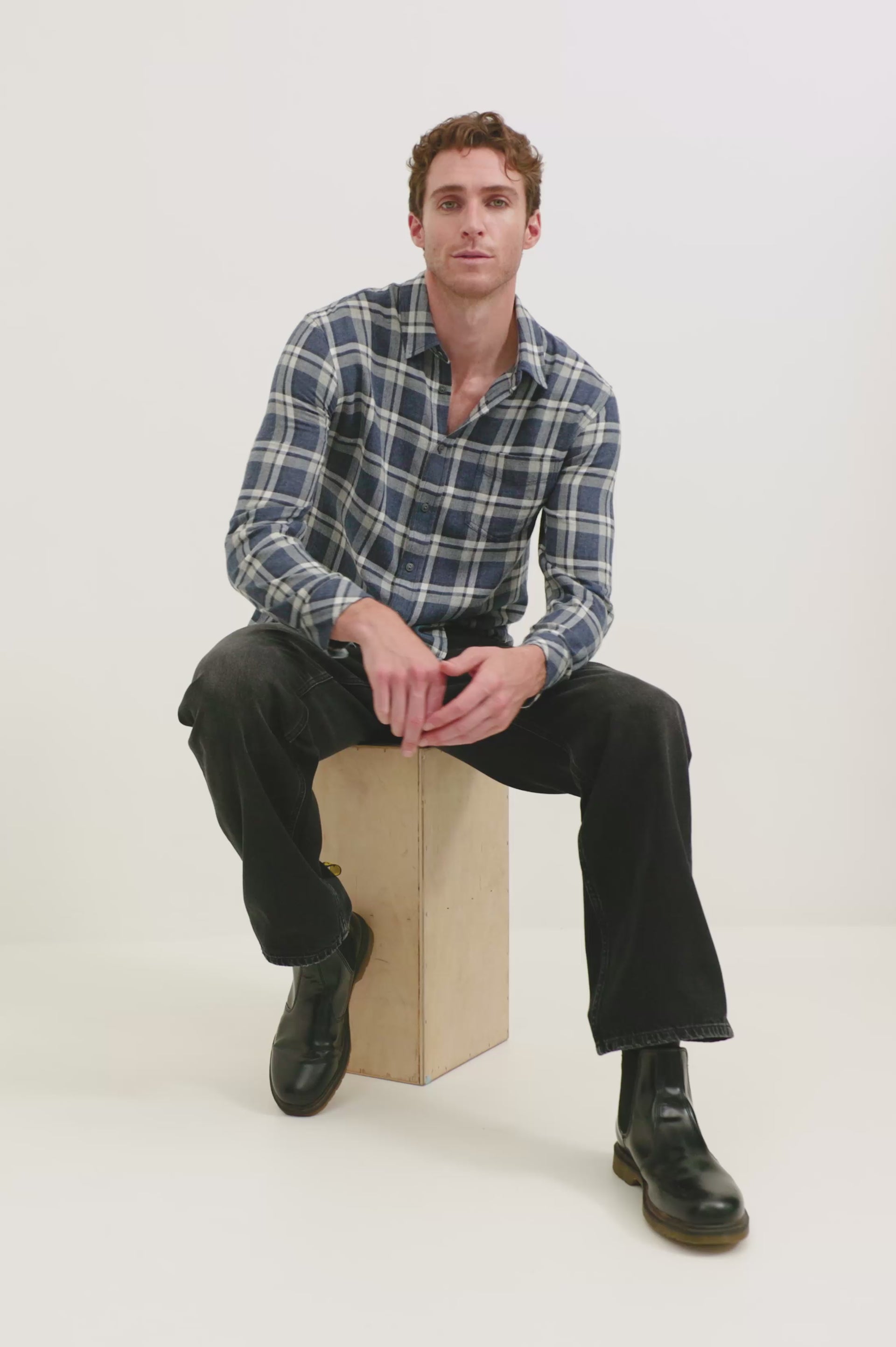 Lennox shirt features a luxe melange yarn fabrication, brushed on both sides for extra softness and lasting comfort. Front view of model sitting featured.