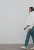(Video): Summit Jacket in Ivory shown on a model to showcase the cropped puffer silhouette, mid-neck collar, and Rails logo arm patch. Full Body View Featured on Model.