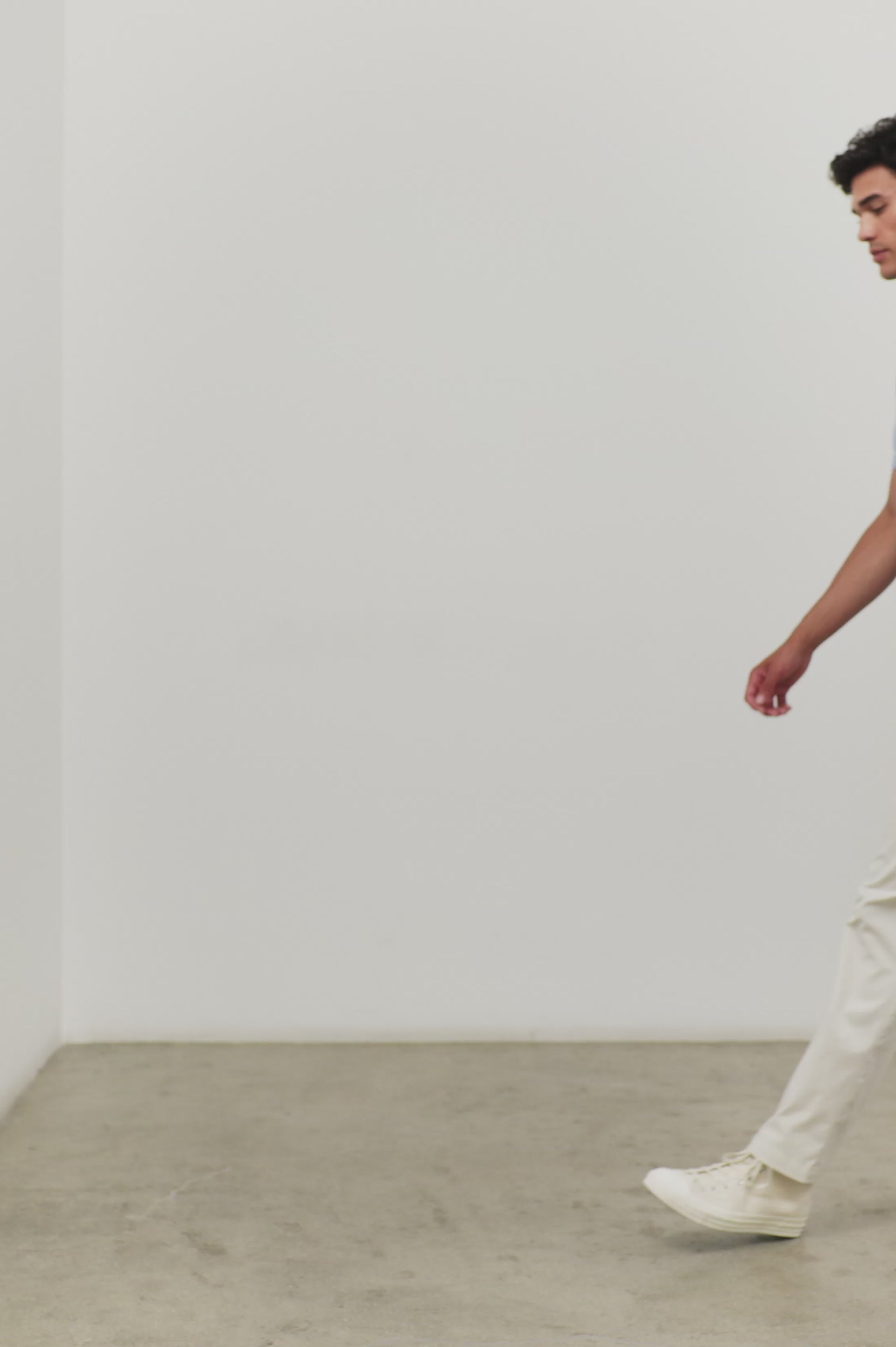 (Video): Men's Hardy polo shirt in light blue melange, shown on a model to demonstrate the breathable knit fit - front full body view featured on model.