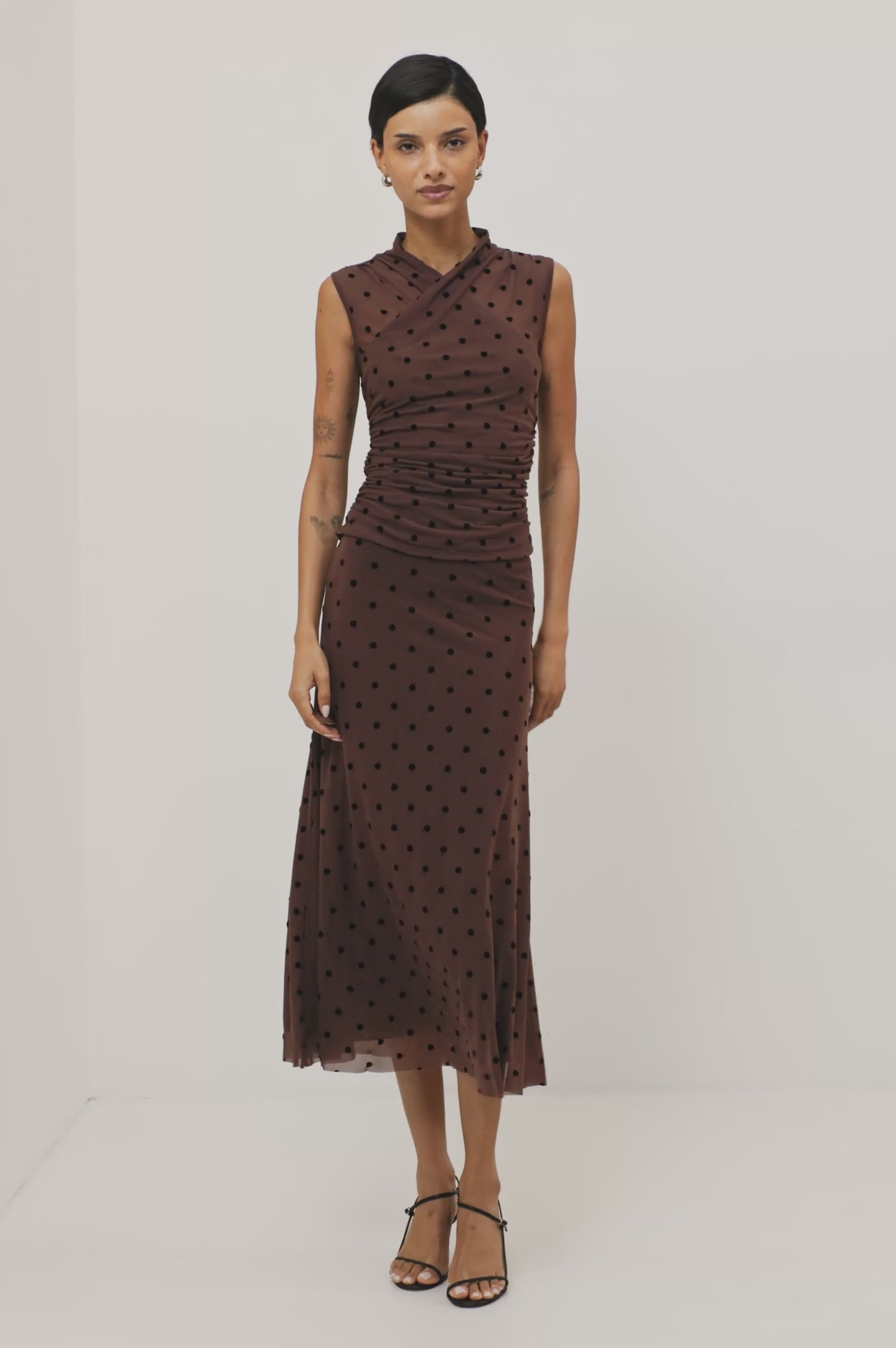 Jordan Midi Skirt in Stretch Mesh With Velvet Flocked Details, A-Line Fit, Full Lining, and Elastic Waistband in Chocolate Polka Dot Colorway - Lower Body Front View Featured on Model - Video