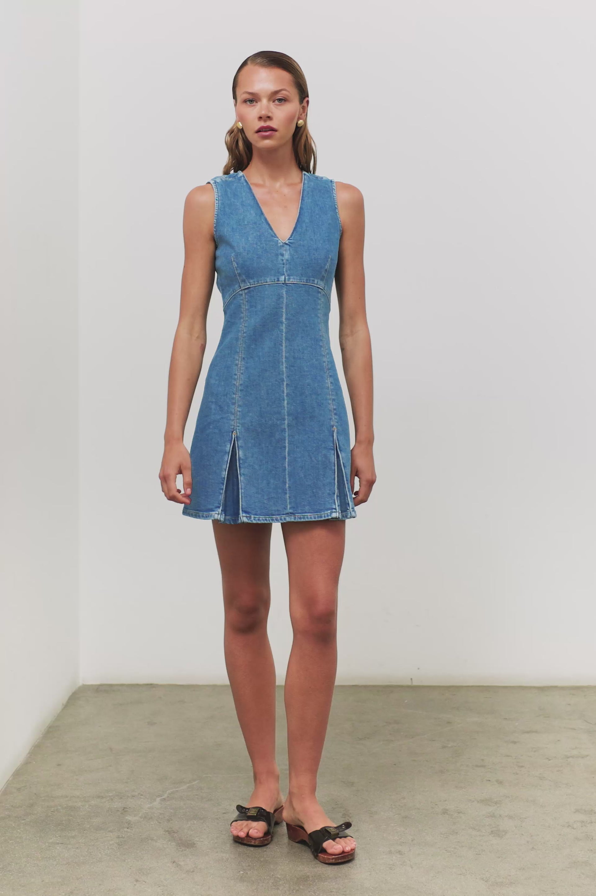 (Video): Serra denim dress in Bristol wash, showing the button-down front and cinched waist on a model - front full body view on model.