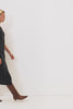 Westwood Sleeveless Denim Midi Dress with Belt Loops, a Button and Zipper Closure for the Skirt and Button Closure on the Bodice, a V neck, a Front Center Thigh Slit, Two Front Pockets and Two Back Patch Pockets in Black Pearl Colorway, a washed black- Front Full Body video Featured on Model.