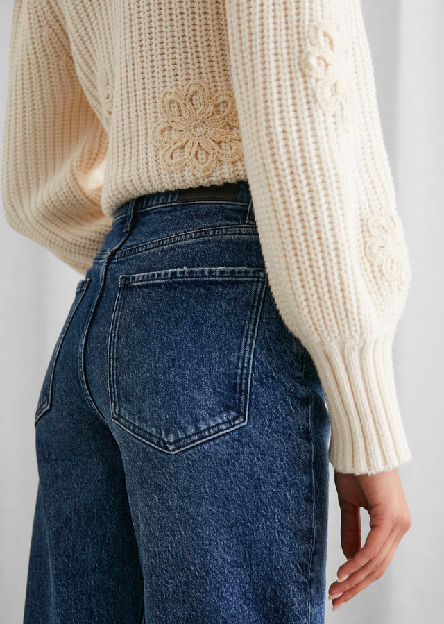 BACK DETAIL IMAGE OF MODEL WEARING ROMY SWEATER AND GETTY WIDE LEG JEANS