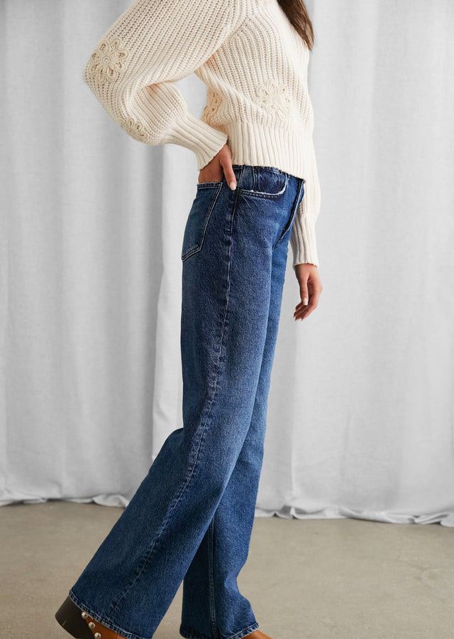 SIDE IMAGE OF MODEL WEARING ROMY SWEATER AND GETTY WIDE LEG JEANS