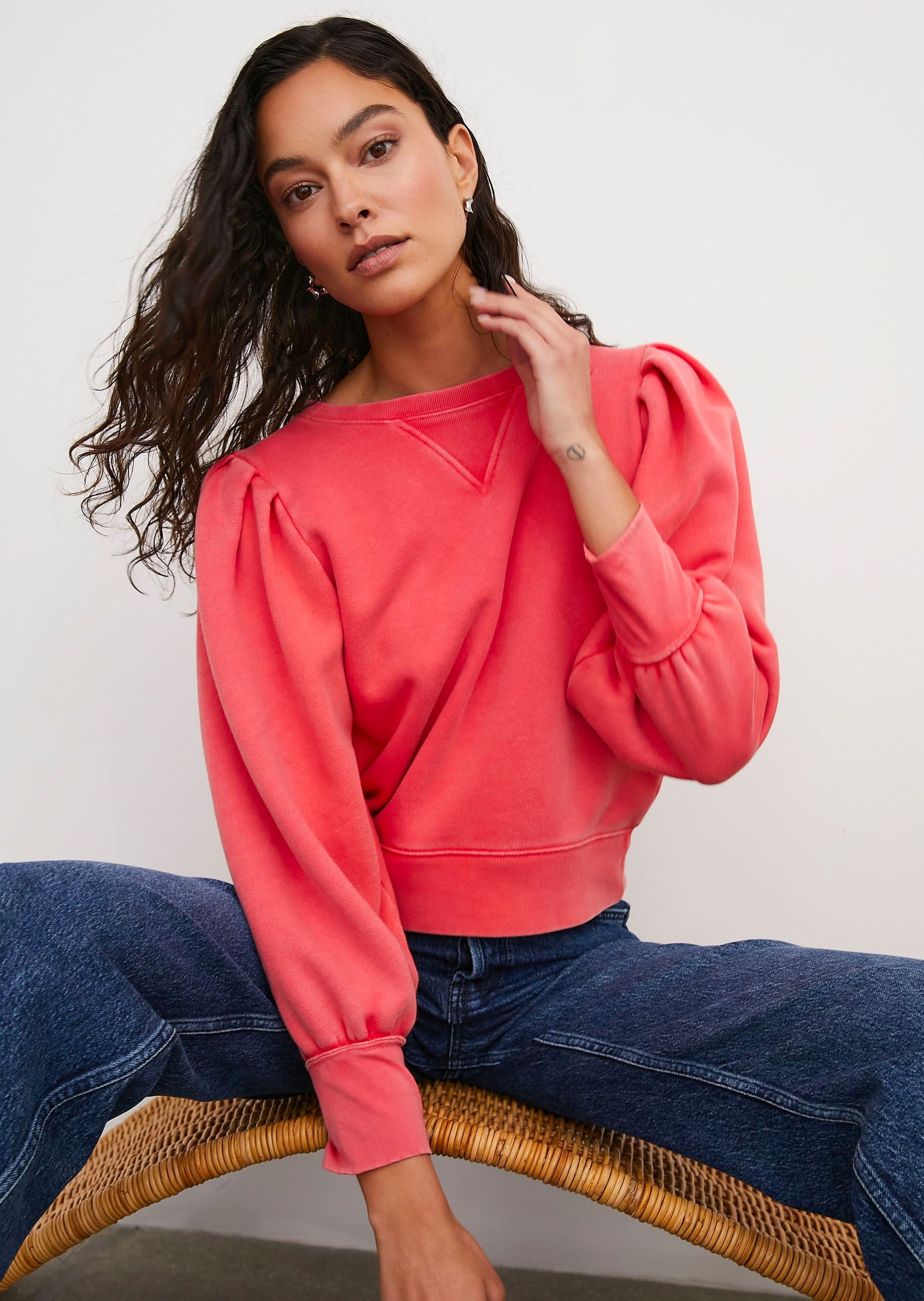 FRONT IMAGE OF MODEL SITTING WEARING TIFFANY SWEATSHIRT