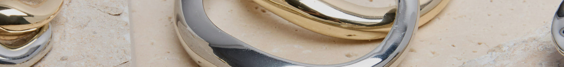 Up-close image of silver and gold jewelry