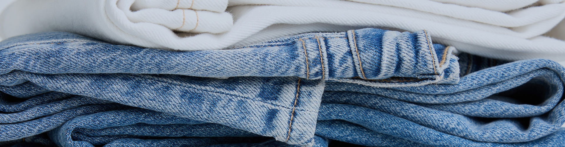 Stack of folded blue and white jeans 