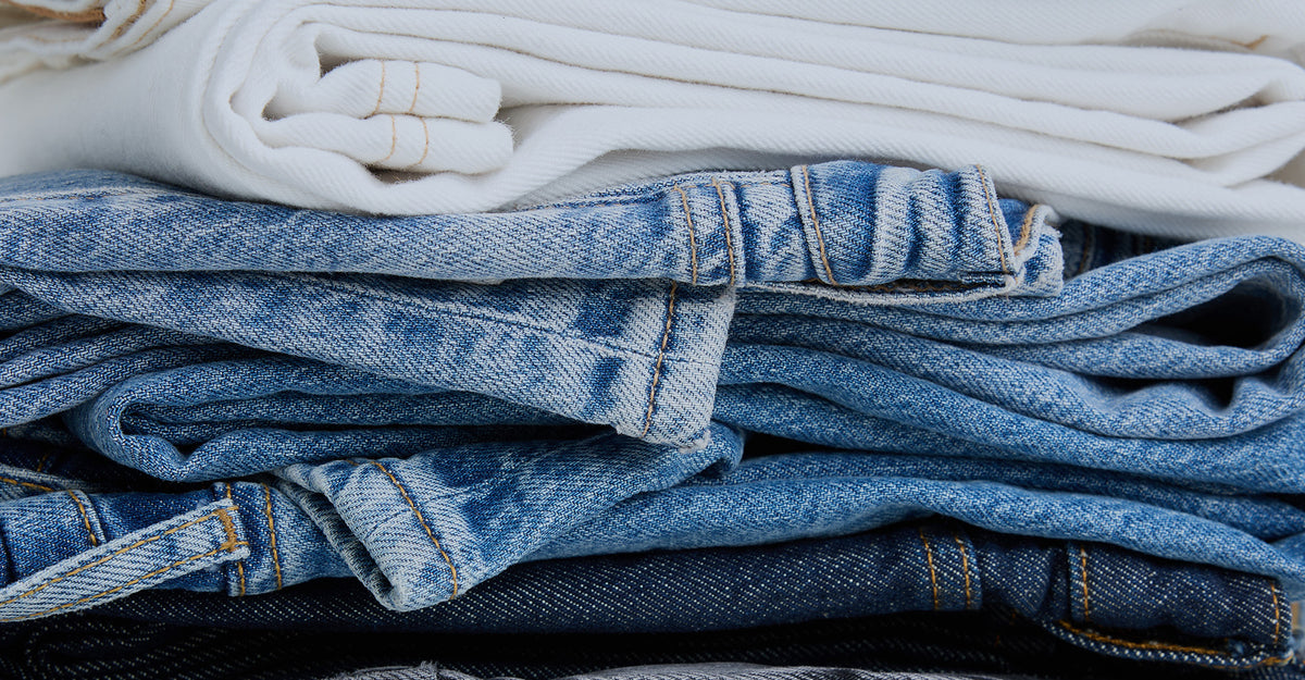 Stack of folded blue and white jeans 