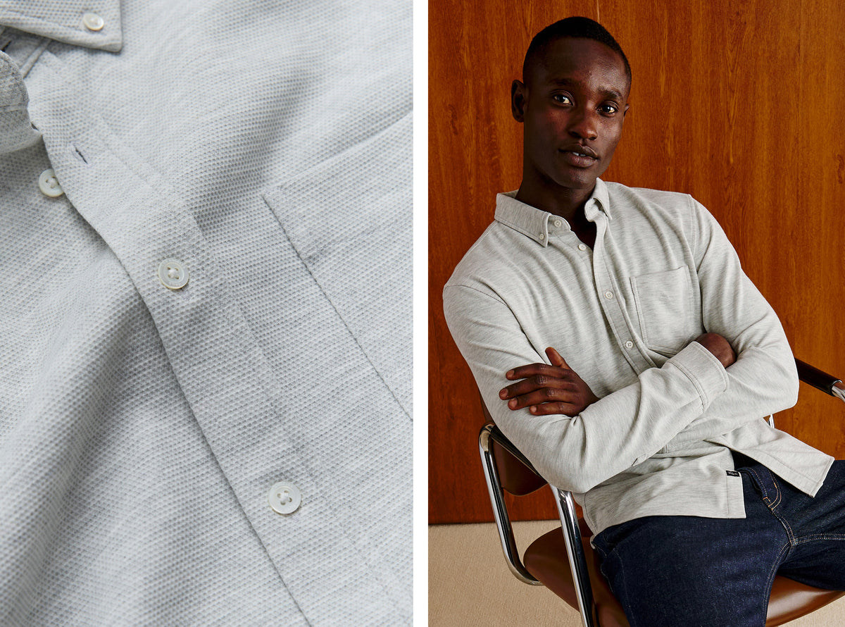 A split image showing a close-up of a light gray textured long-sleeve button-up shirt on the left, and a man wearing the shirt in a studio setting with a wood-paneled background on the right.